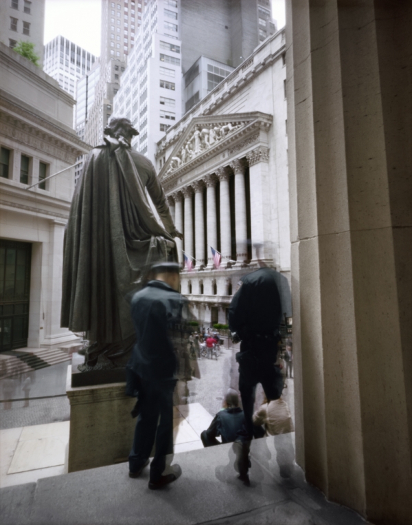 Photo of Wall Street with statue and two figures