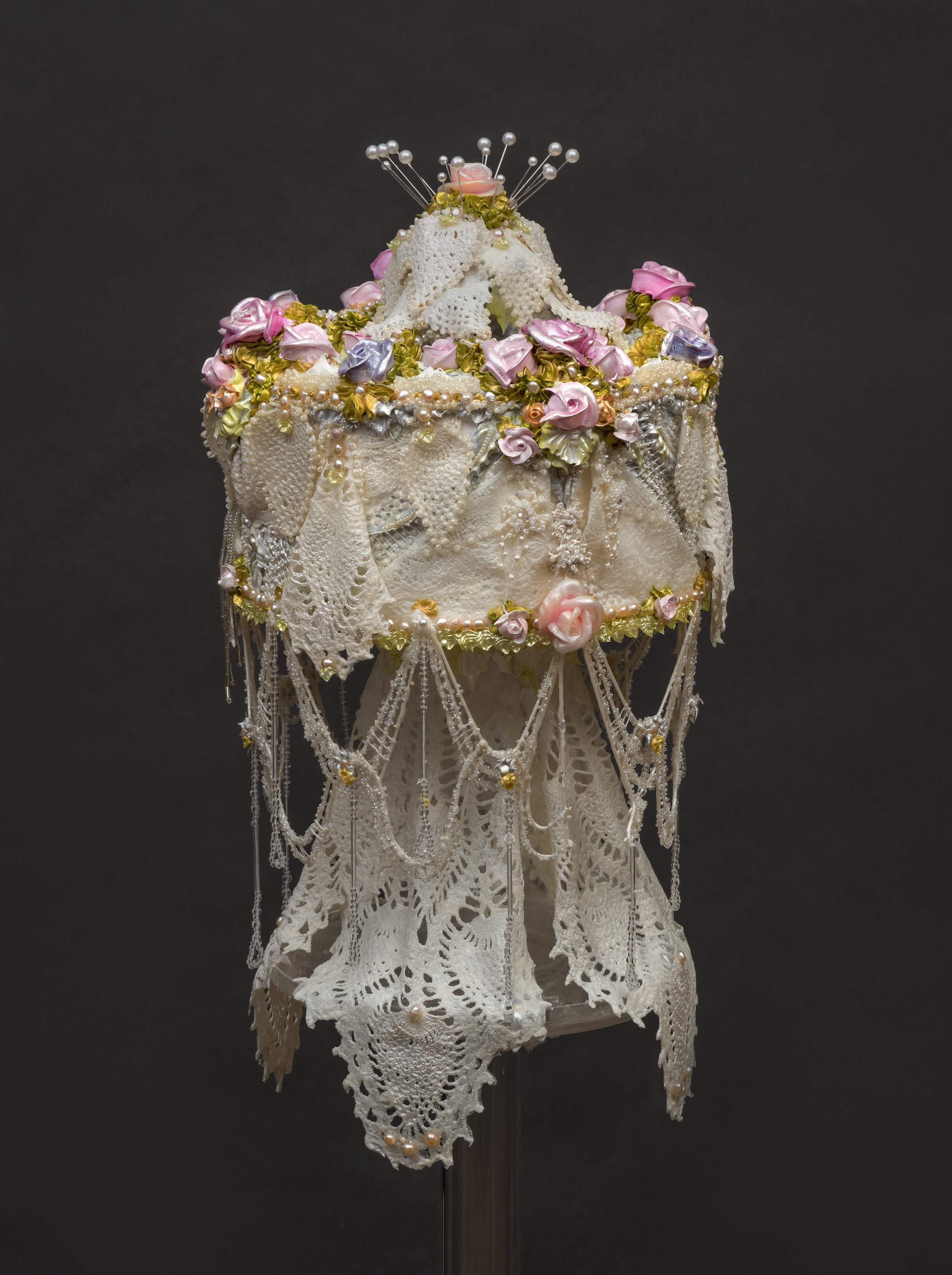 Pat Lasch &lt;alt: Cake decorated with pink roses, gold and silver piping, pearls, pins, and draped in white lace &lt;/&gt;