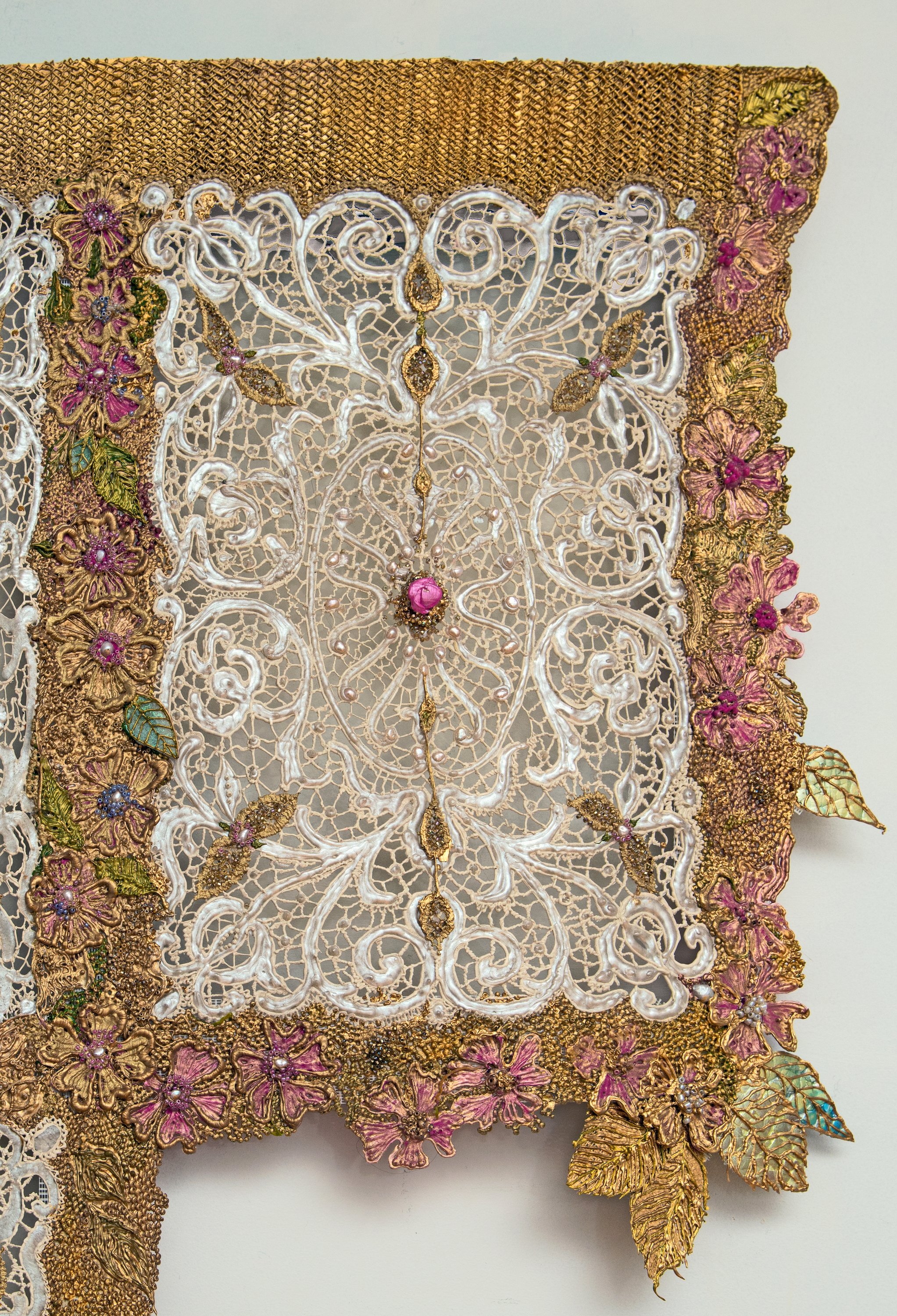 Detail of double panel garment of acrylic paint lace, flowers, and leaves in white, gold, pink, and green.