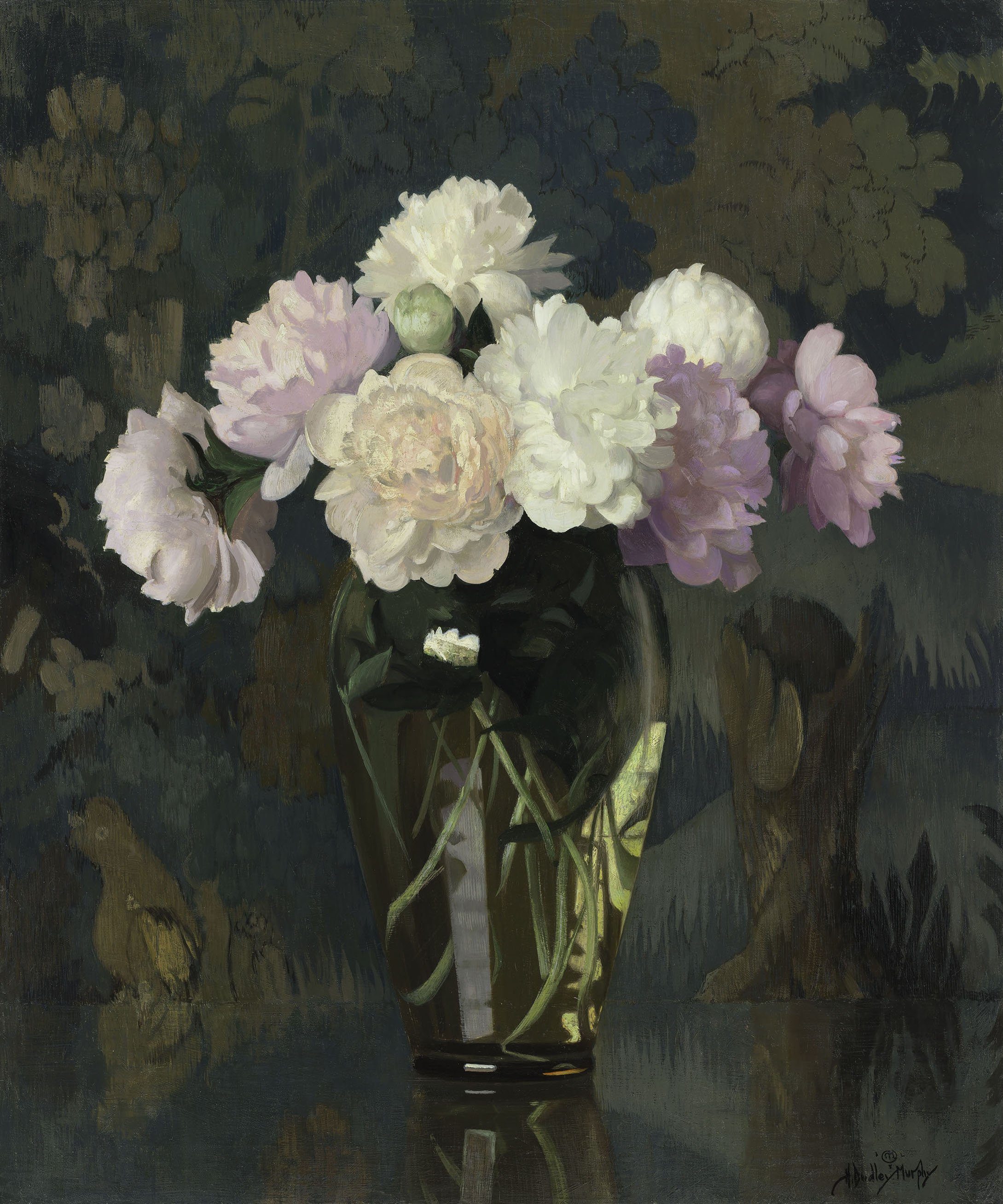Still life of white, pink, and peach peonies in a glass vase on a table with a green-blue forest tapestry behind.