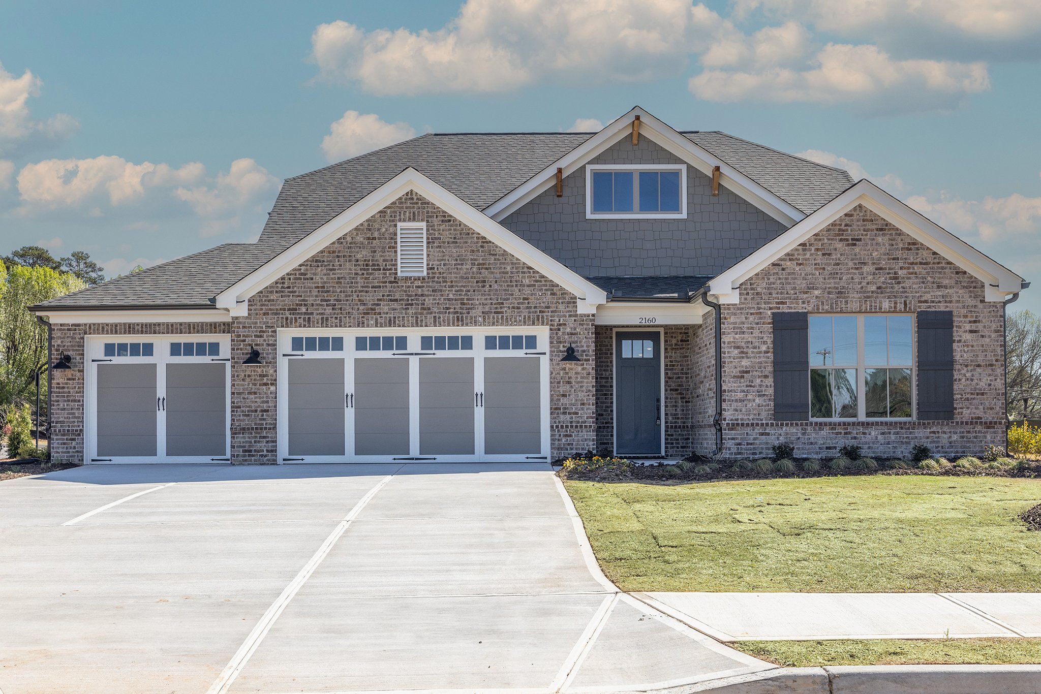 002-Front Exterior with 3rd Car Garage.jpg