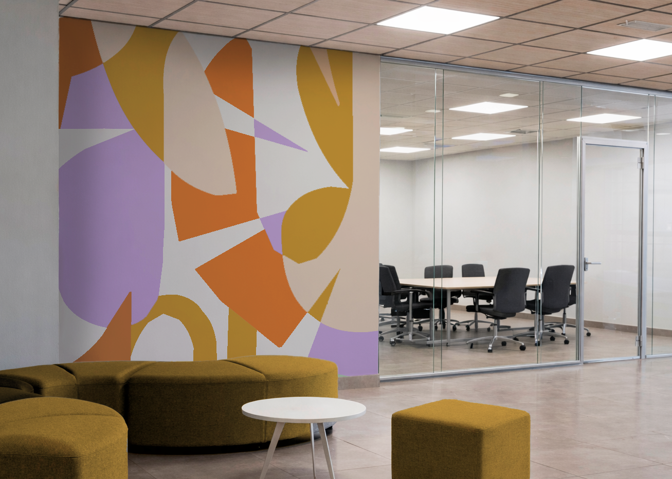 Modern office lounge with an abstract mural, mustard-colored sofa, white coffee table, and a glass-walled conference room with black chairs inside.