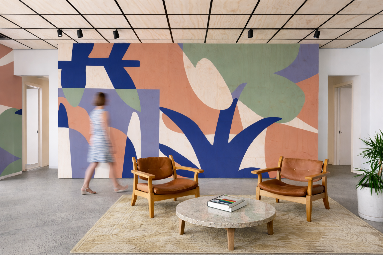 Colorful, abstract, botanical mural with large-scale shapes located in an open lounge area in a workplace environment.