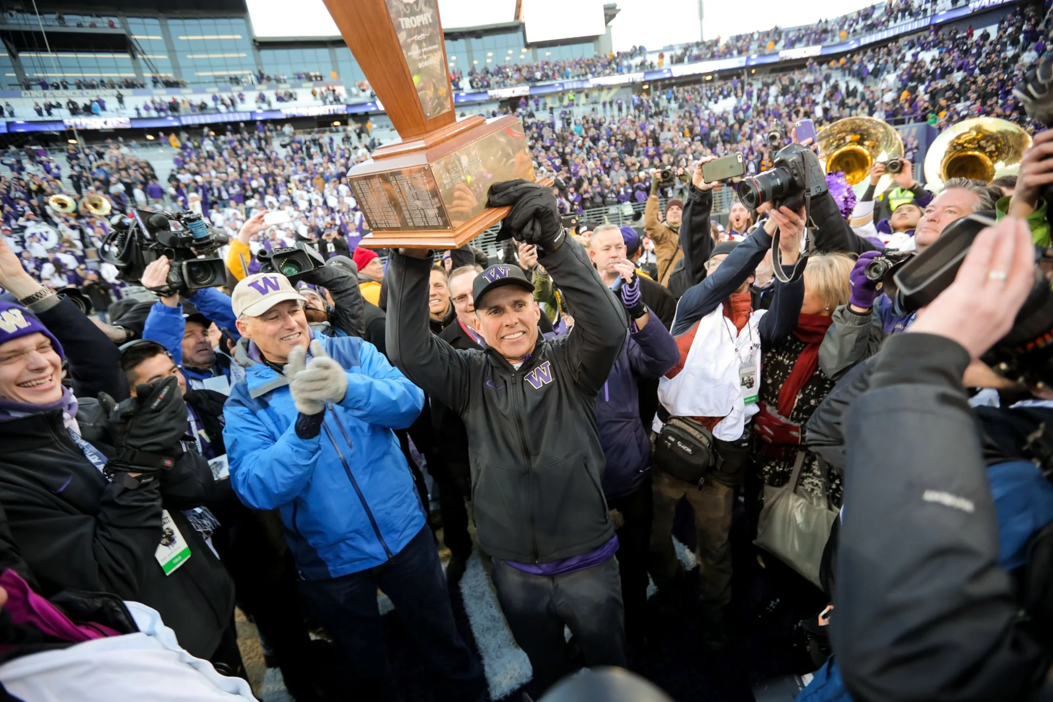University+of+Washington+Huskies+Football+Head+Coach+Chris+Petersen+Hoists+Apple+Cup+Trophy+after+beating+Washington+State+University+Cougars.jpg