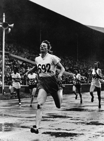 Blankers-Koen crossing the finish line in the 200-meter event, 1948 (photo via Getty images).