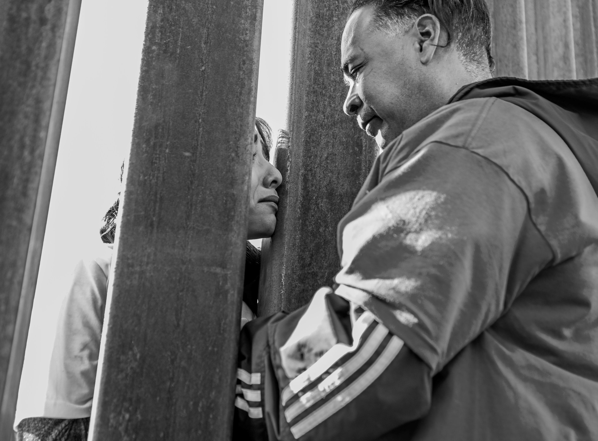 The Correa family attempt to embrace through the steel bars of the Anapra border wall between the U.S. and Mexico on Dec. 10, 2017. Each family had three minutes to talk and embrace each other.