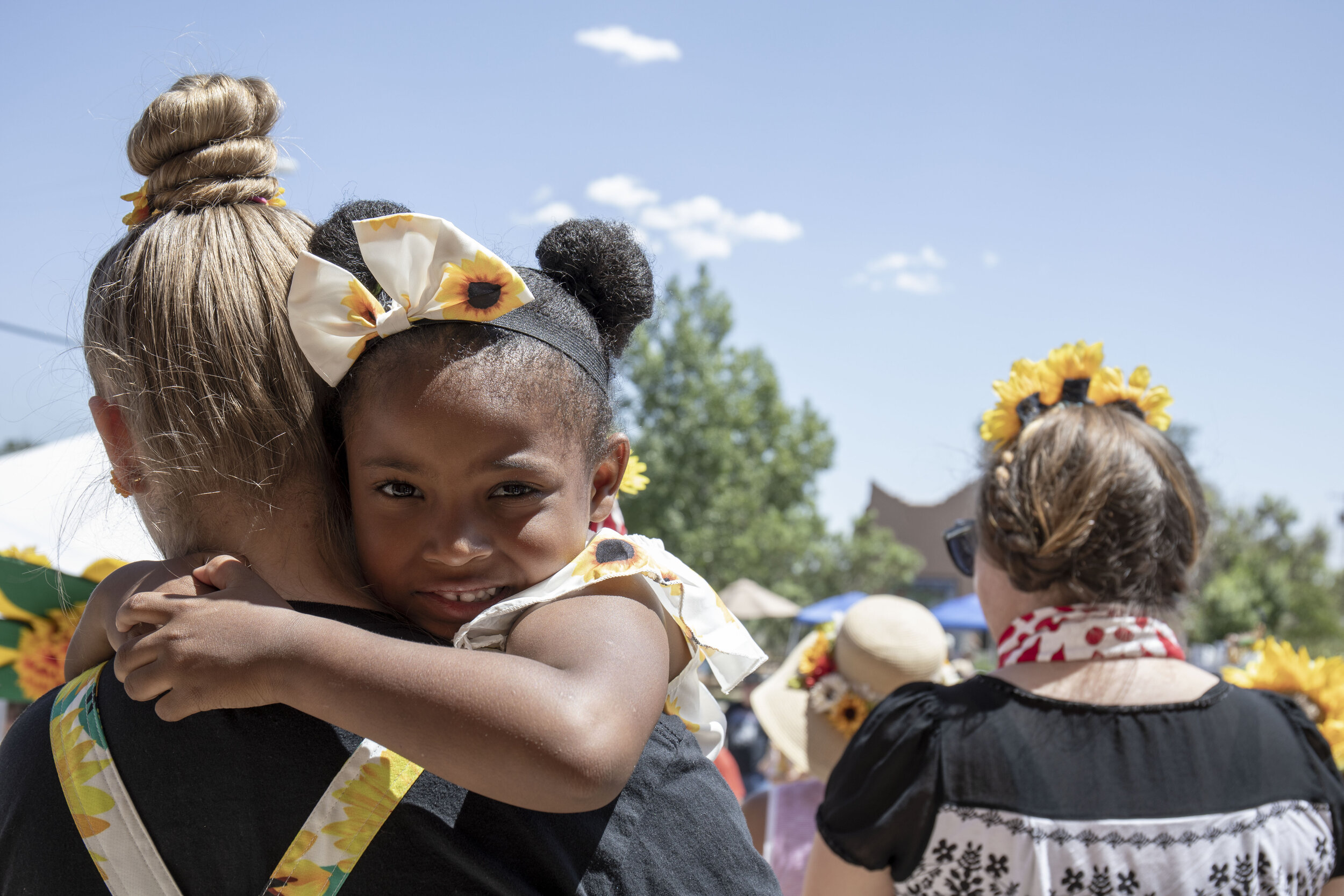 Alex Nieto holds her little sister Zamaya Nieto, 3, before the hat parade where they were contestants.