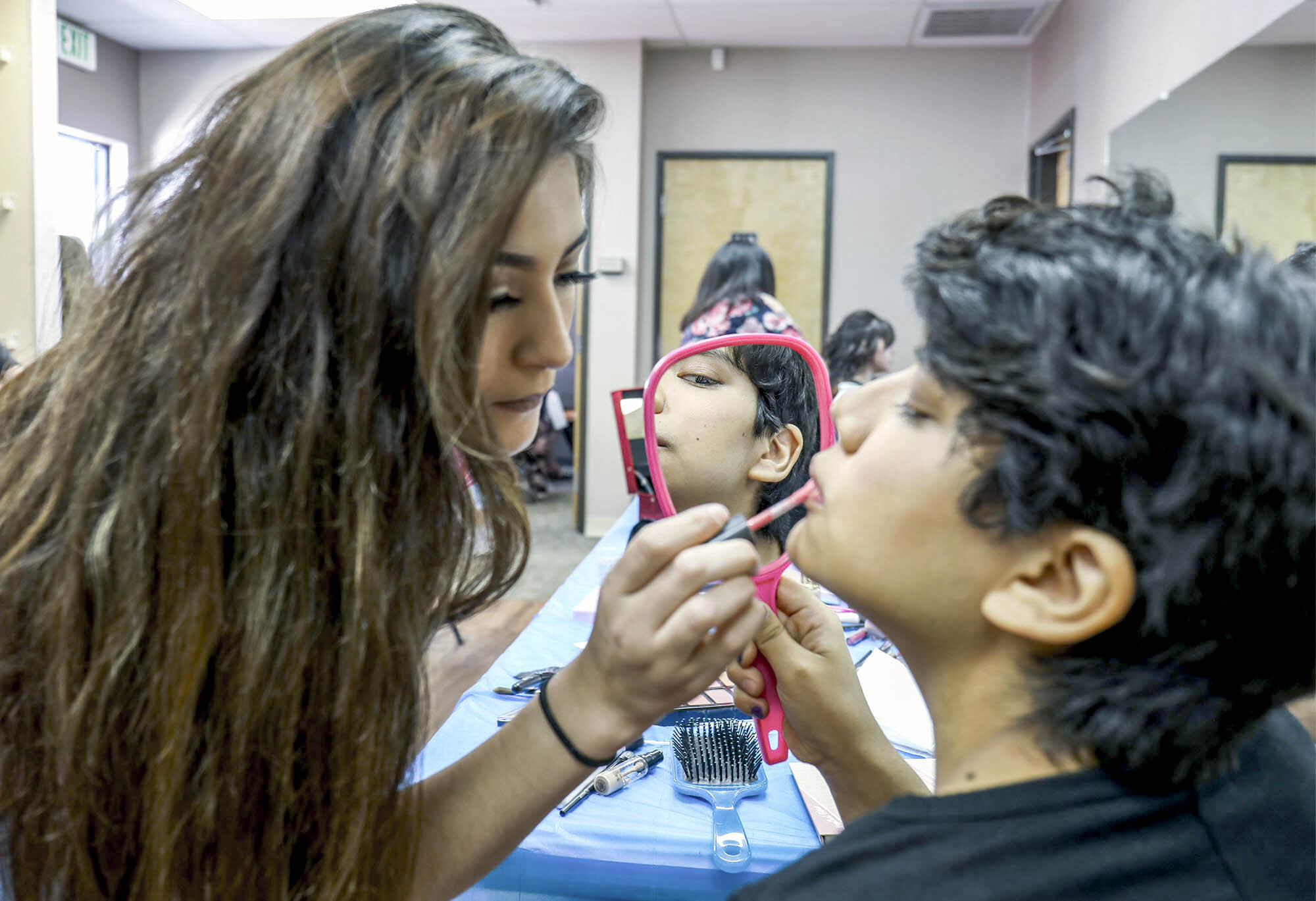  Volunteer, Genesis Baca, 18, left does the make up of Heaven Leigh Patterson, 19, for the fifth Annual Special Needs Prom. Patterson drove down from Pojoaque with her mother to attend the event and will be graduating from the school in two weeks. Th