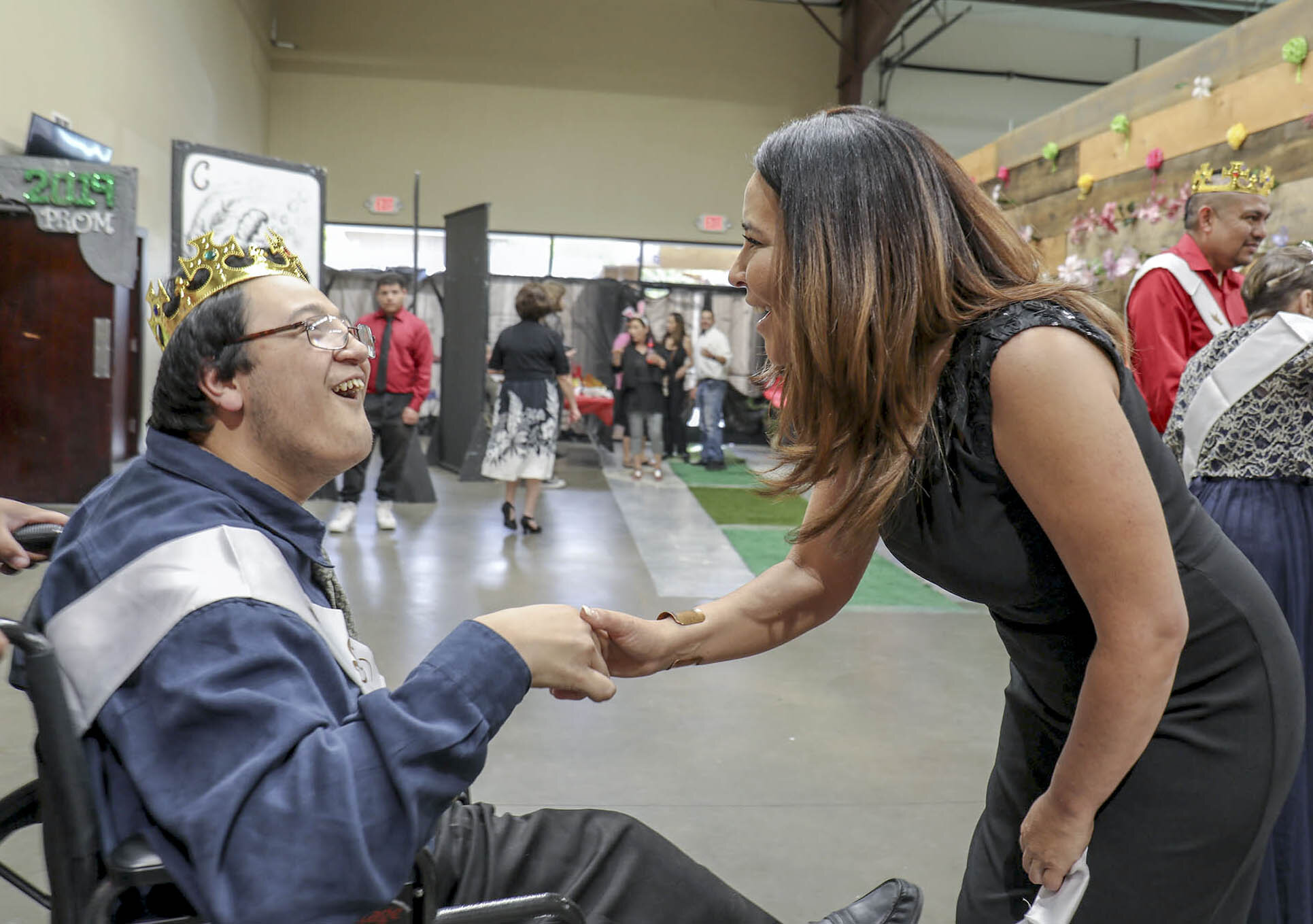  Angelique Chavez greets Rogerio “Roe” Contreras, 23, during the special needs gala event. The event welcomes individuals with special needs from all ages. Chavez was inspired to begin the event due to her two children with special needs. 