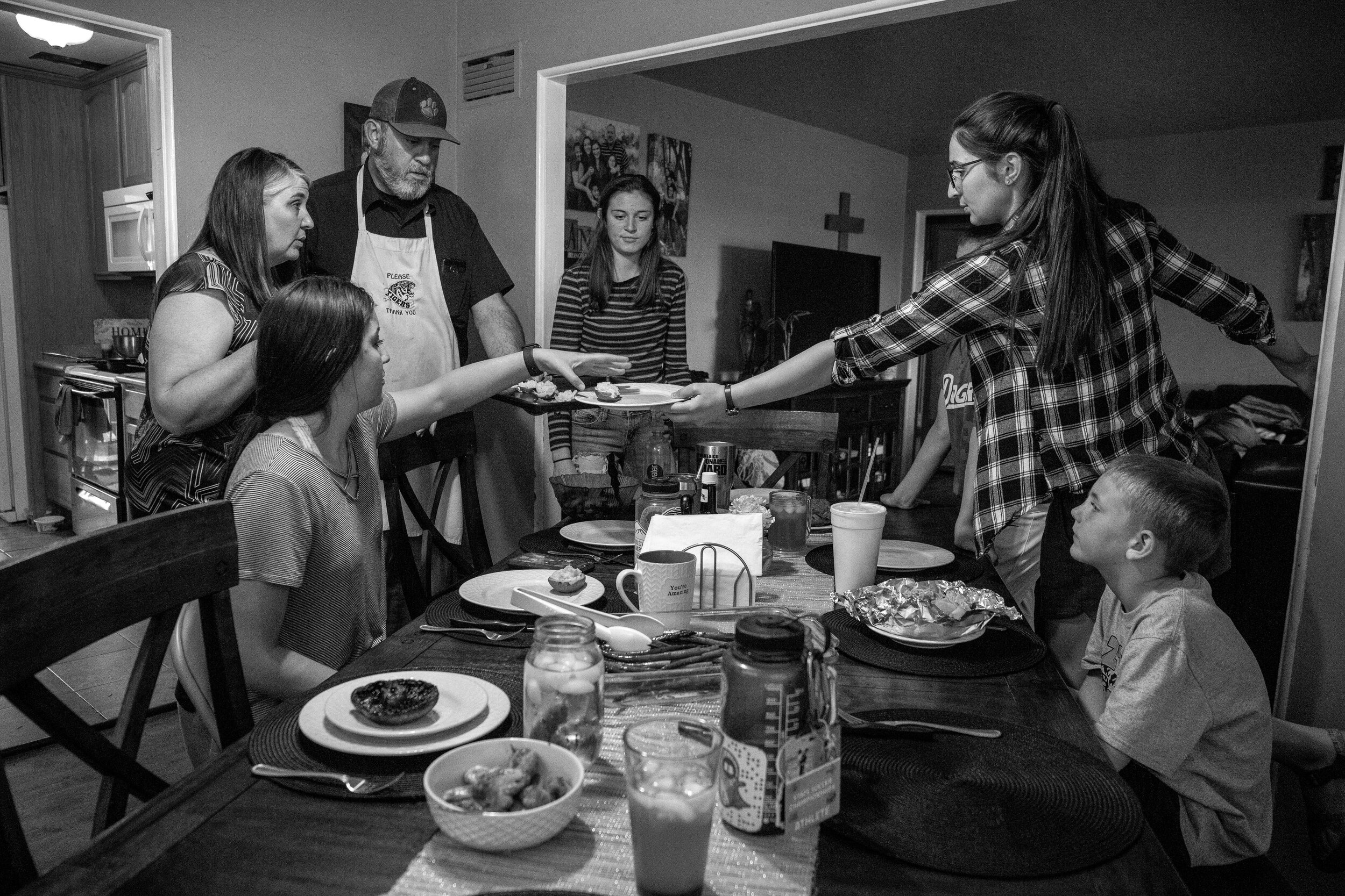  The Sanders gather to eat dinner on Wednesday afternoon. The family celebrated an early birthday dinner for Daniella while her oldest sisters were still in town. 