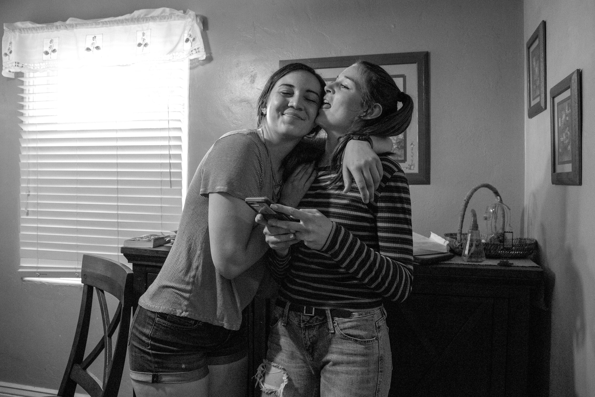  Daniella licks Sierra’s face as Sierra goes in for an embrace before dinner Wednesday evening. Both Sierra and Daniella are survivors of the Aztec High School shooting. For Sierra her Christian faith has been one of her main comforts in attempts to 