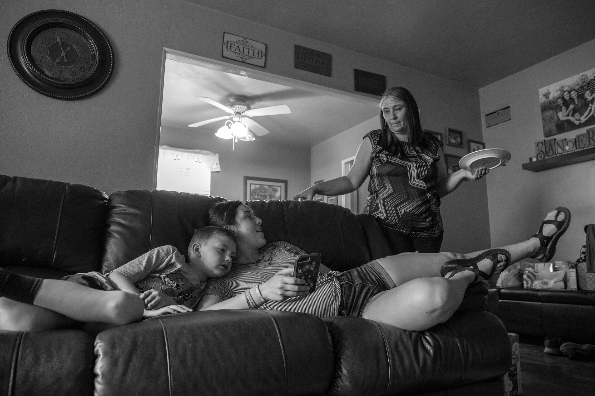  Sierra relaxes on the couch with her cousin Wyatt Salisbury, 7, while she talks to her mom Charda about leaving for her summer job in the morning. Sierra will be a summer Camp Counselor in Glorieta, New Mexico from May until August before returning 