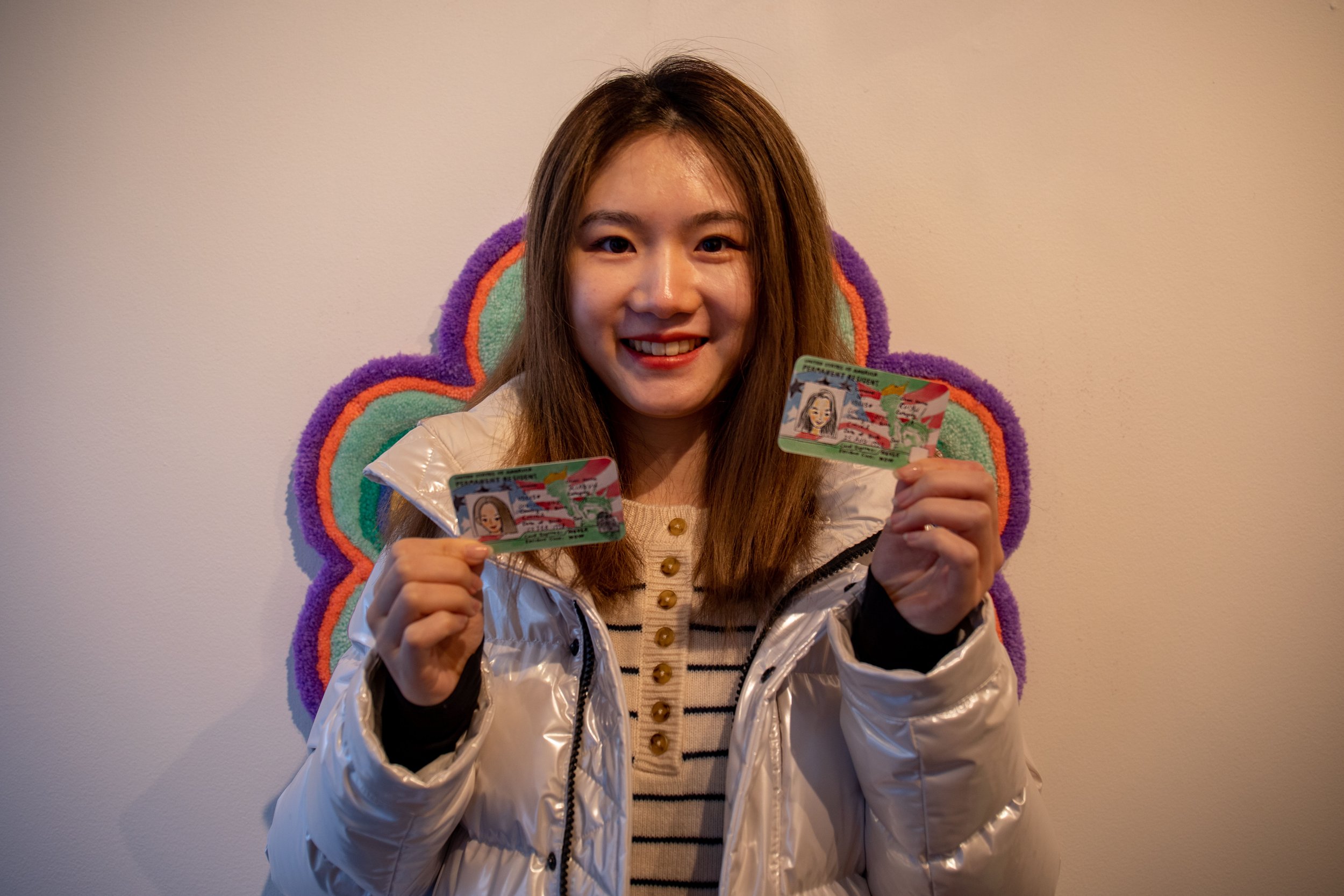  Xiaoyu Li shows her finished green cards at the fair at Brick Aux. Li is from China and has been in NY since 2016. 