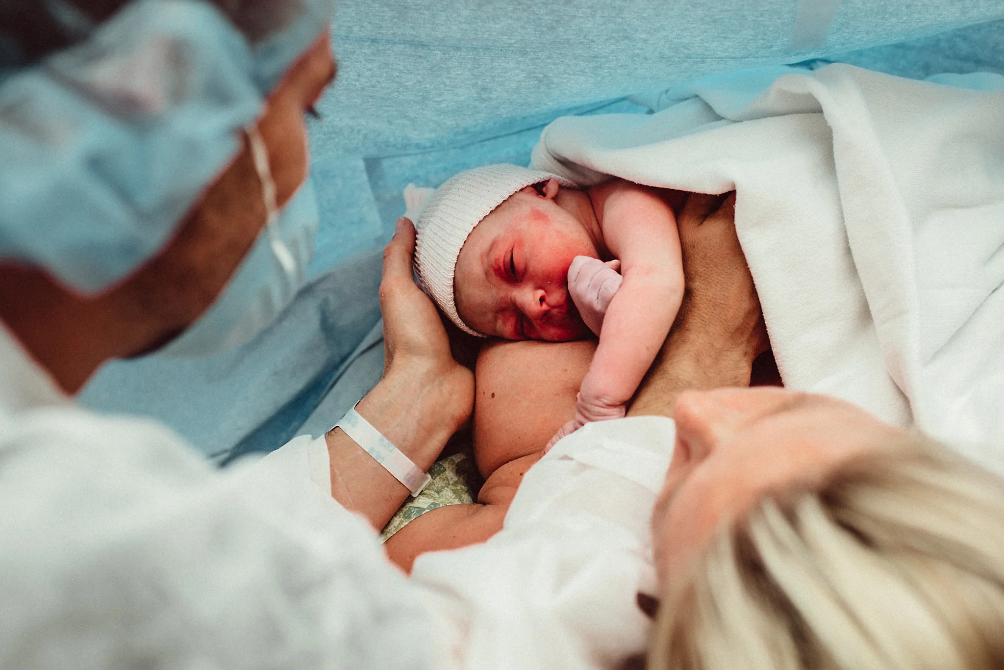 Dad and Mom admire new baby after cesarean
