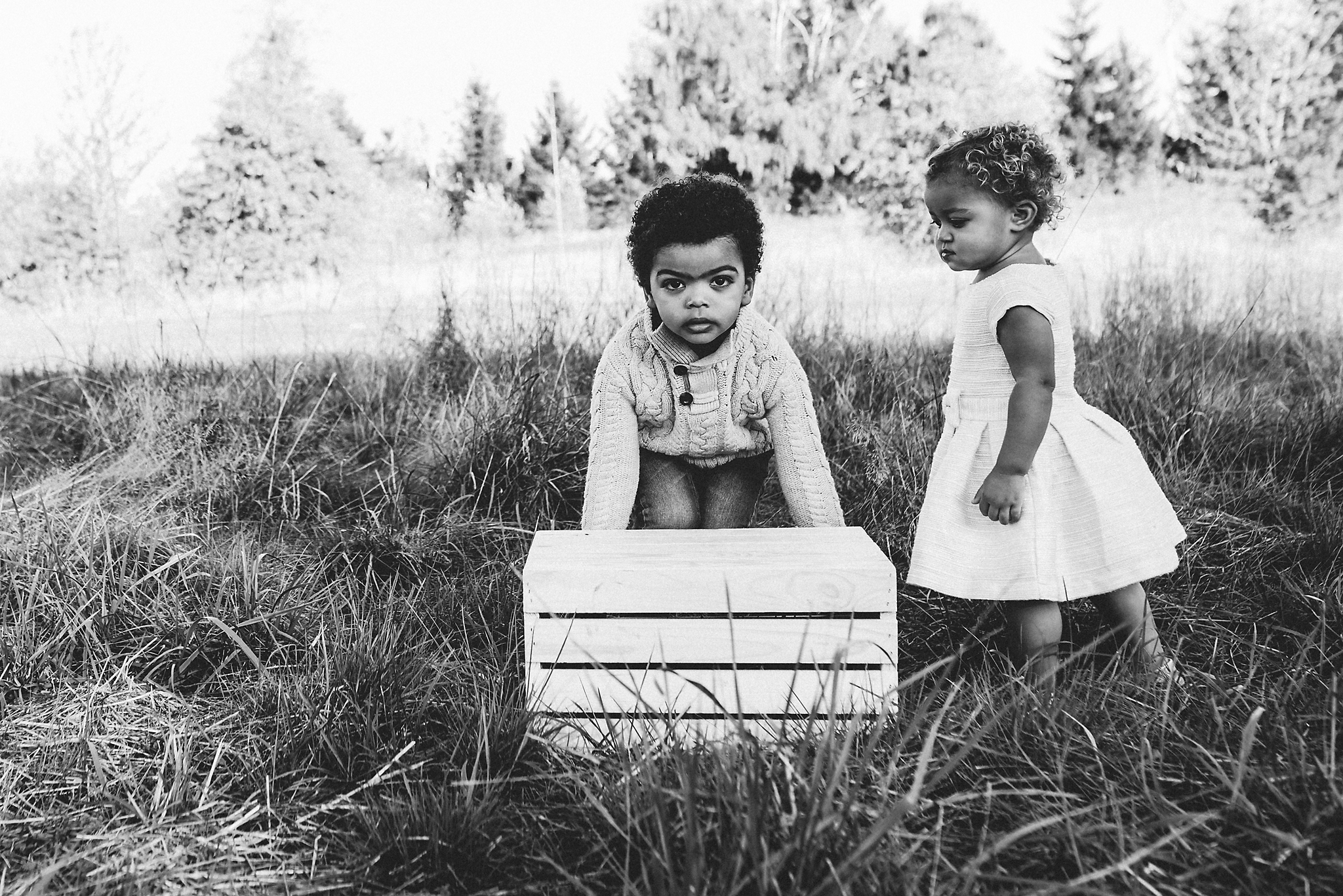 Two children move box at Luscher Farm