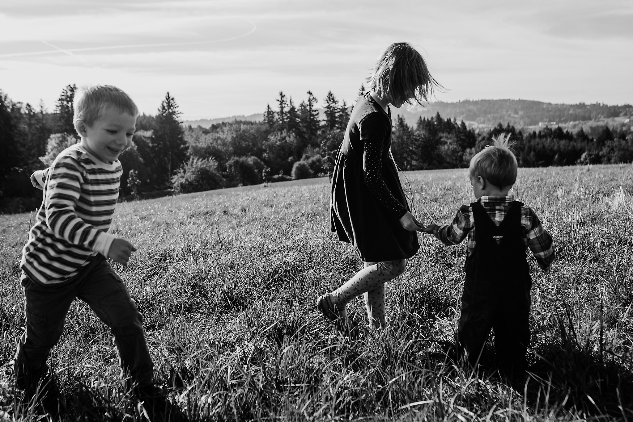 Three kids playing in field