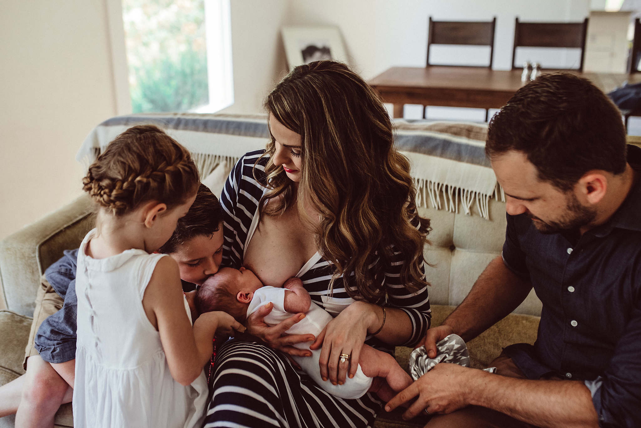Mom nurses newborn in home
