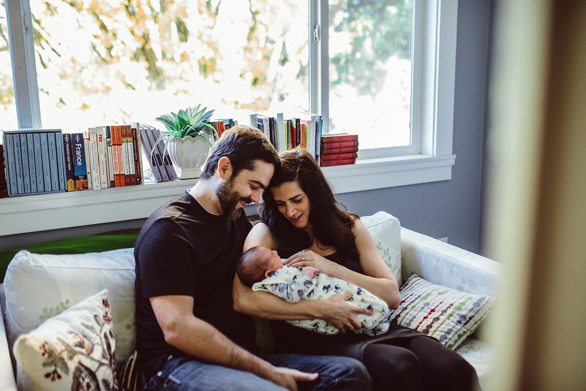 Happy Couple with newborn on couch