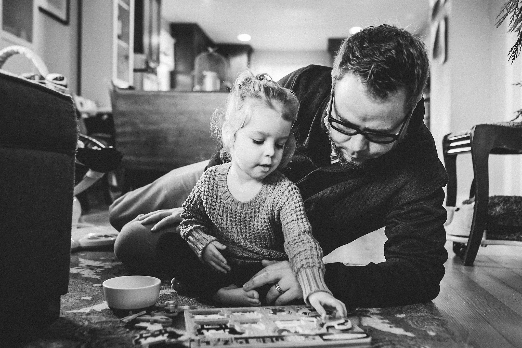 Father and daughter working on a puzzle