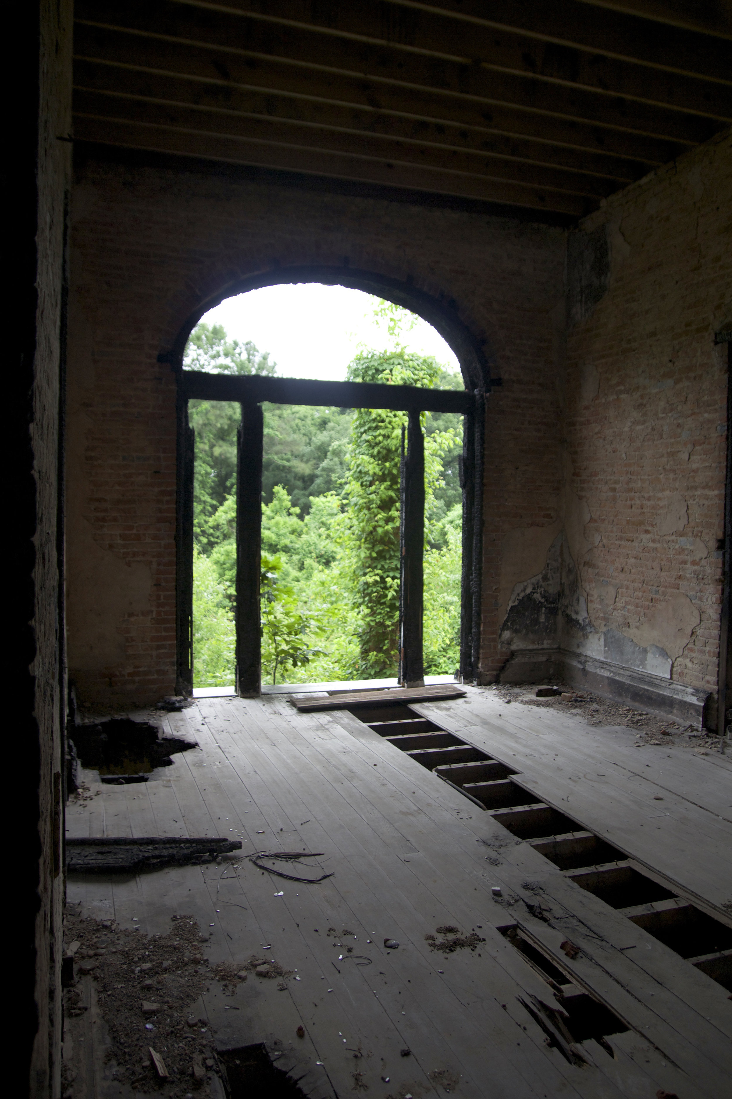 The view from the second floor central hall. The exposed beams from the ceiling and surrounding the door are damaged from the the 2002 fire.