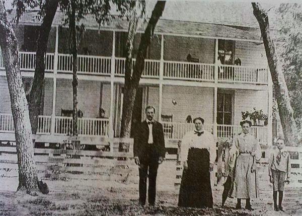 The Lyman Lee Family standing in front of their boarding house