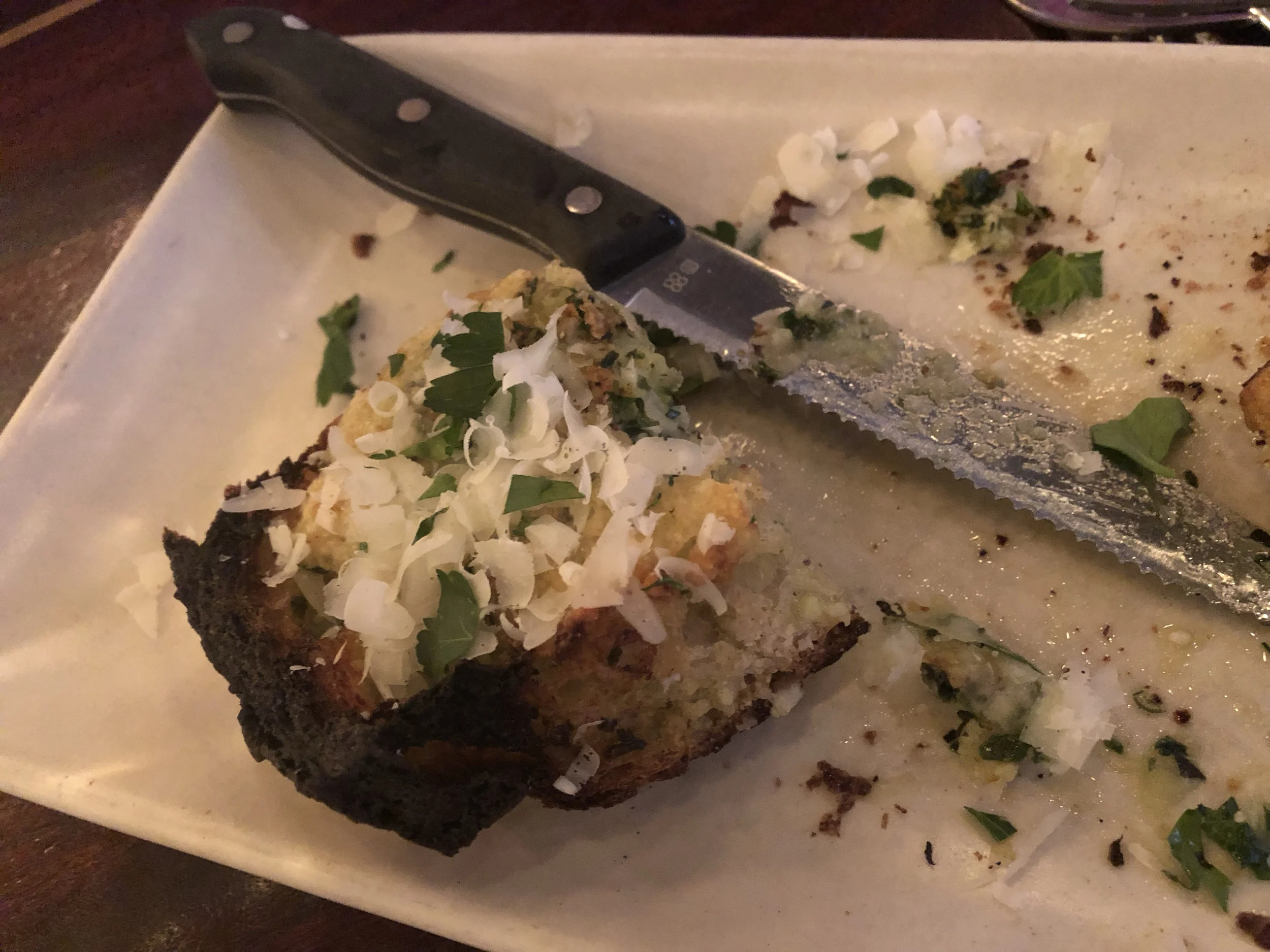  Here is the garlic bread I am speaking of…just look at these amazing ingredients! Toasted baguette with shaved parmesan, cilantro, fresh garlic, butter, sharp white cheddar, pepper, oh wow….so good! Seriously, just going for the garlic bread and selections off of Ava Gene’s wine list could make for a very nice visit. Belly up to the bar to avoid the need for reservations. Image Courtesy: Dan Meyers 
