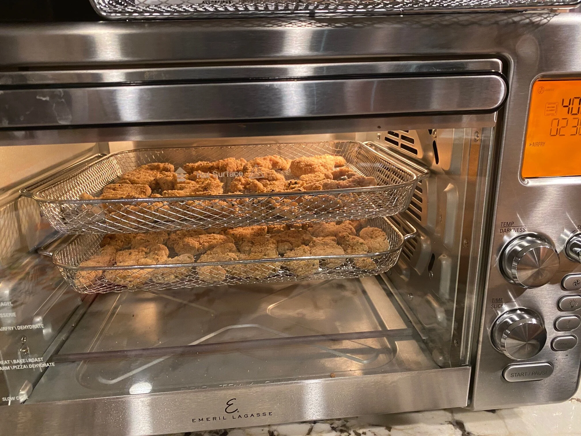 Two trays of delicious, air-fried chicken on the way to becoming delectable! Image Courtesy: Dan Meyers
