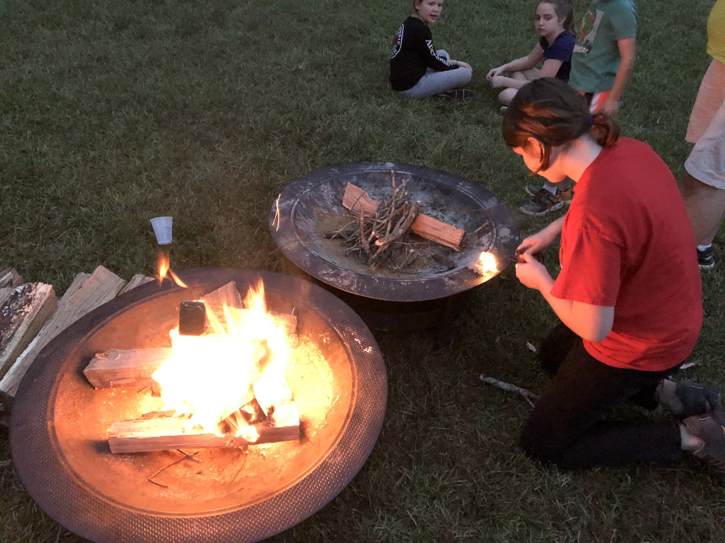 A Scouts BSA scout demonstrating how to start a fire