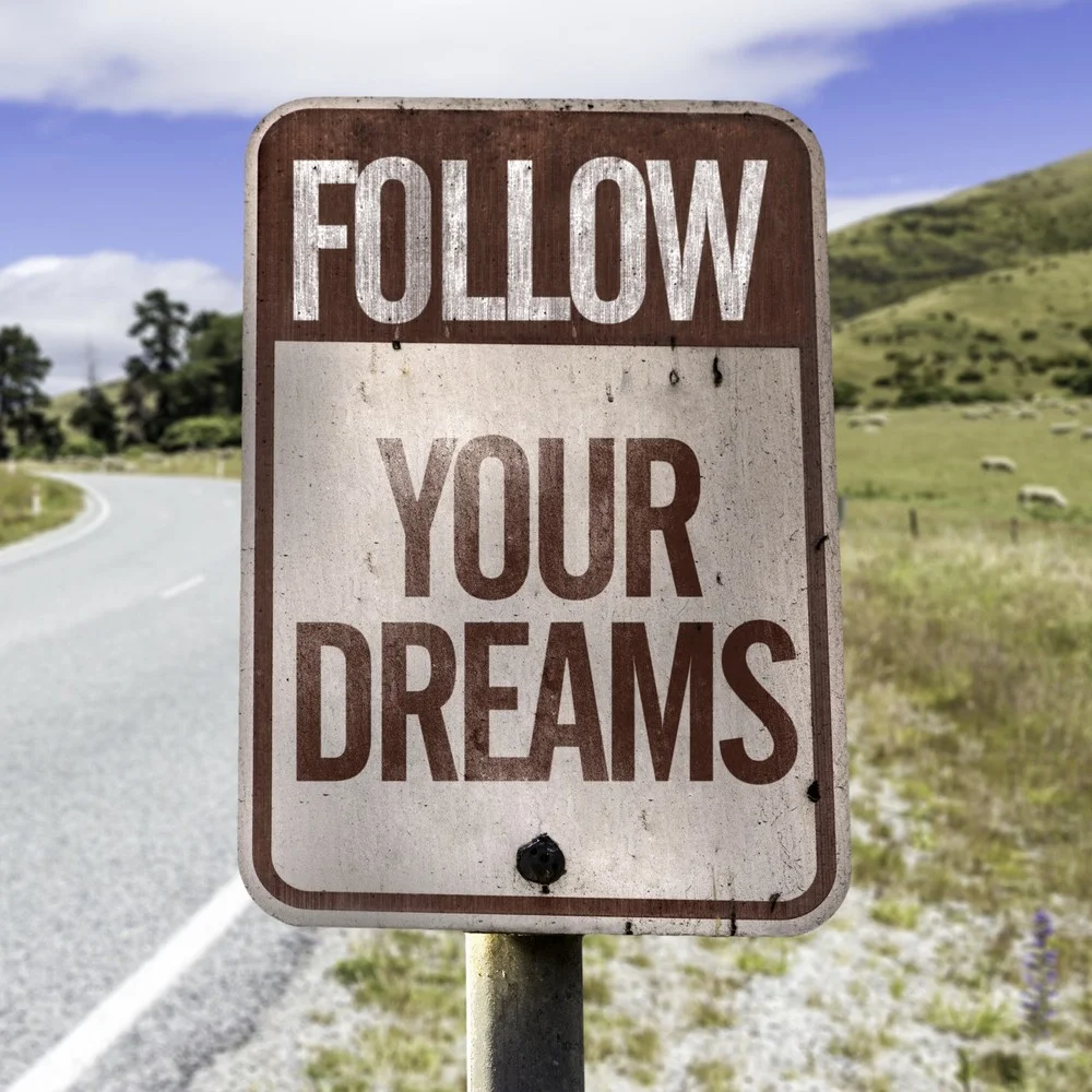 bigstock-Follow-your-dreams-road-sign-o-75557200-e1428766138428 2.jpg