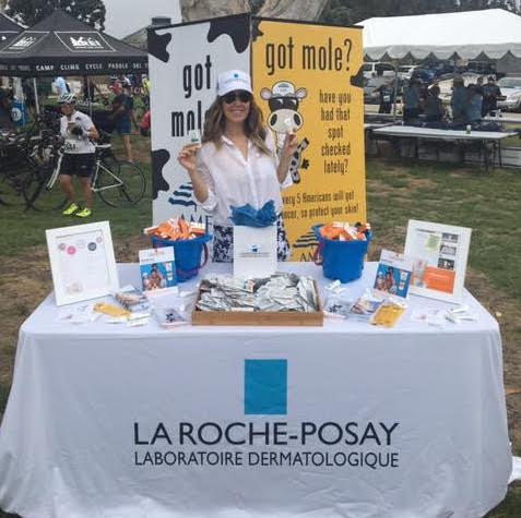 Sara Abraham, Dermatology Sales Manager for La Roche-Posay handing out sunscreen and sun safety bike tips to over 3,000 cyclists.