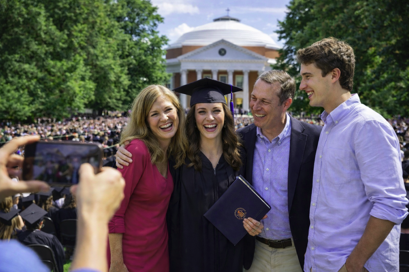 Family celebrating graduation on the Lawn at the University of Virginia with the Rotunda in Charlottesville