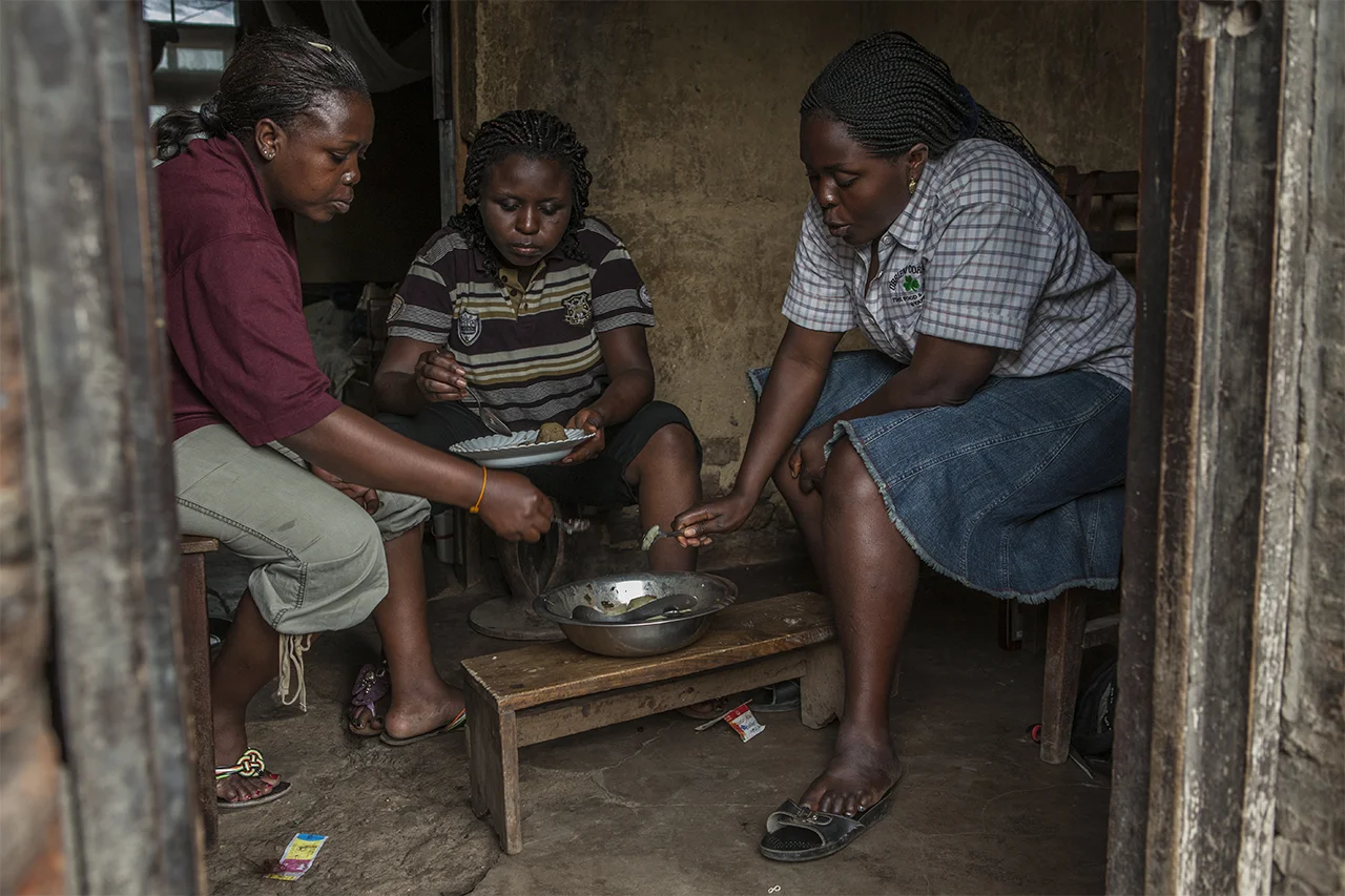 Major Mathilde Samba, Major Masika and a friend share a meal. Kiwanja, North Kivu, DRC