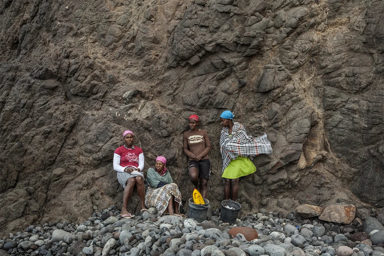 Ja and other workers of Charco wait for men, who will take care of the collecting sand from the sea. Charco, Ribeira da Barca, Santiago, Cape Verde