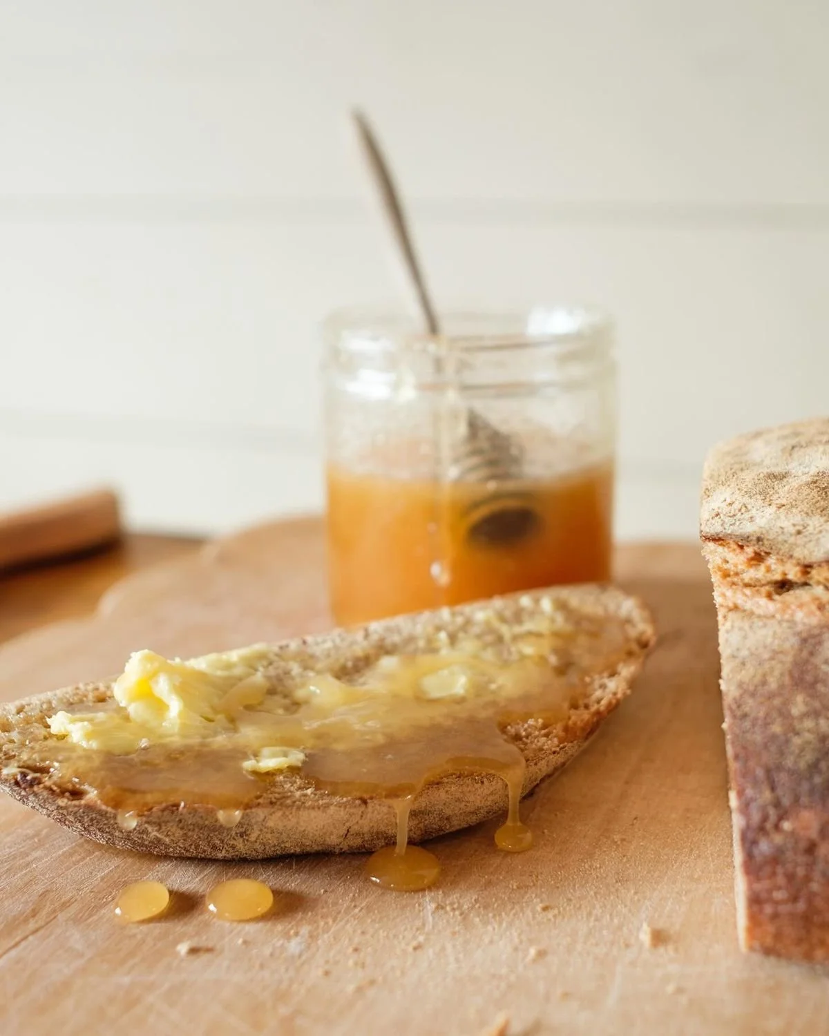 a jar of raw honey with bread and butter