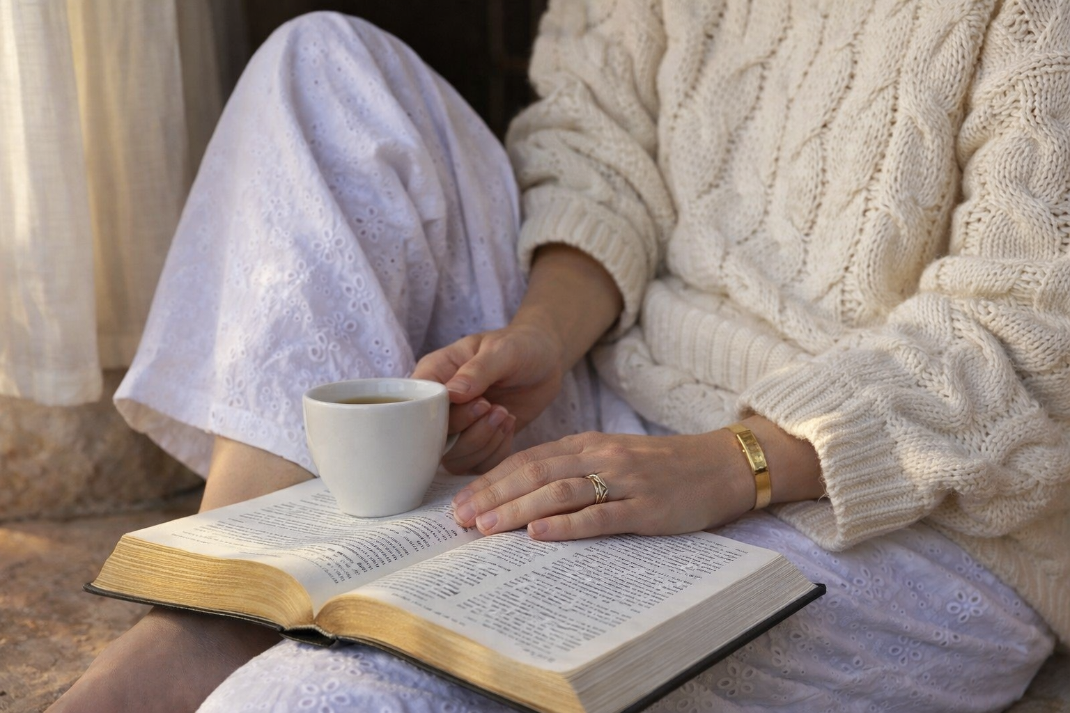 Open Bible in natural light with gold wedding band and bracelet, quiet faith reading