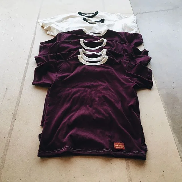 “ Black on Cream Detroit Tees ” and “ Cream on Maroon Detroit Tees ”. (Photo courtesy of Josh York )