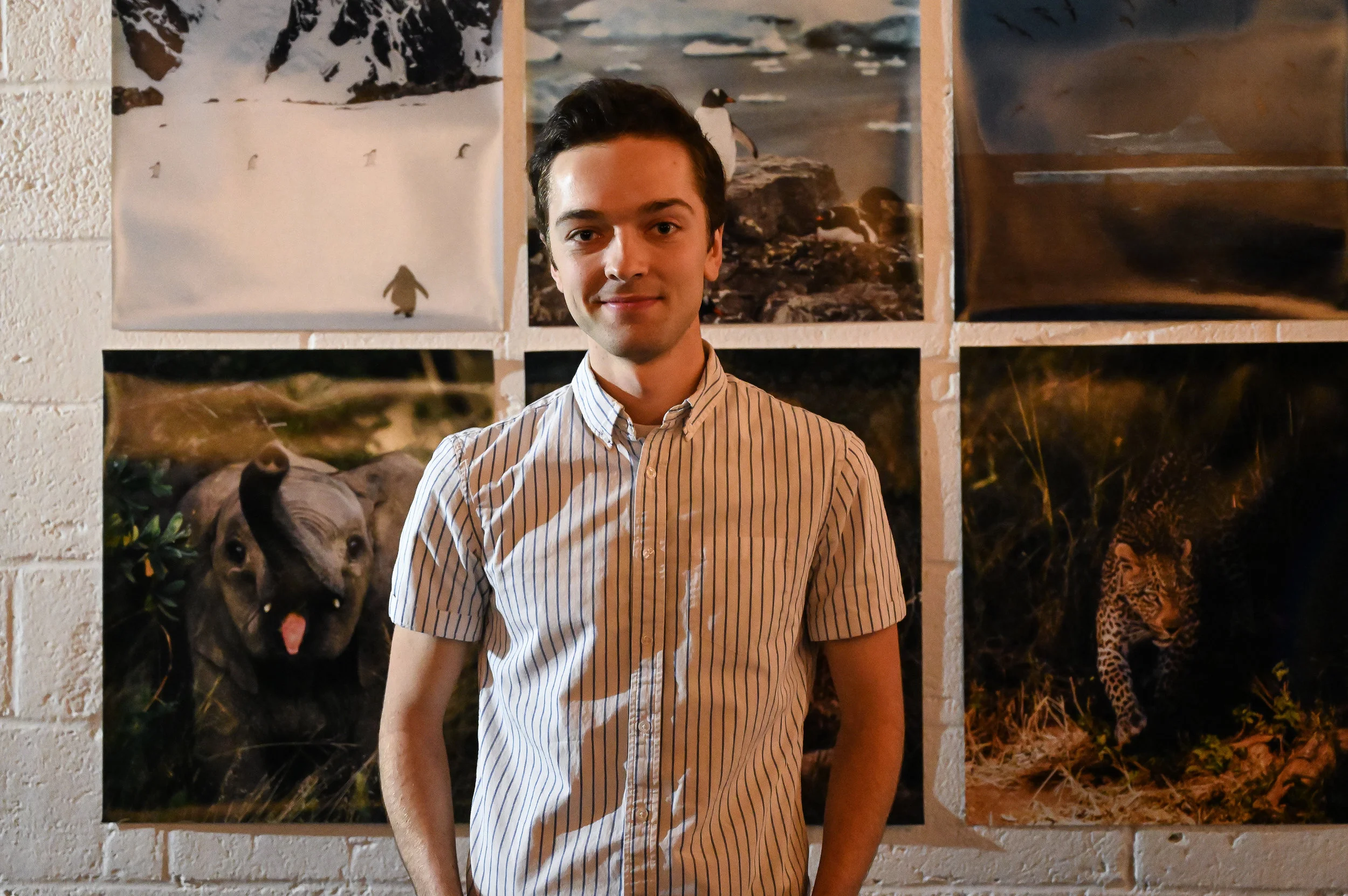 Joe Thomas in front of his photography.
