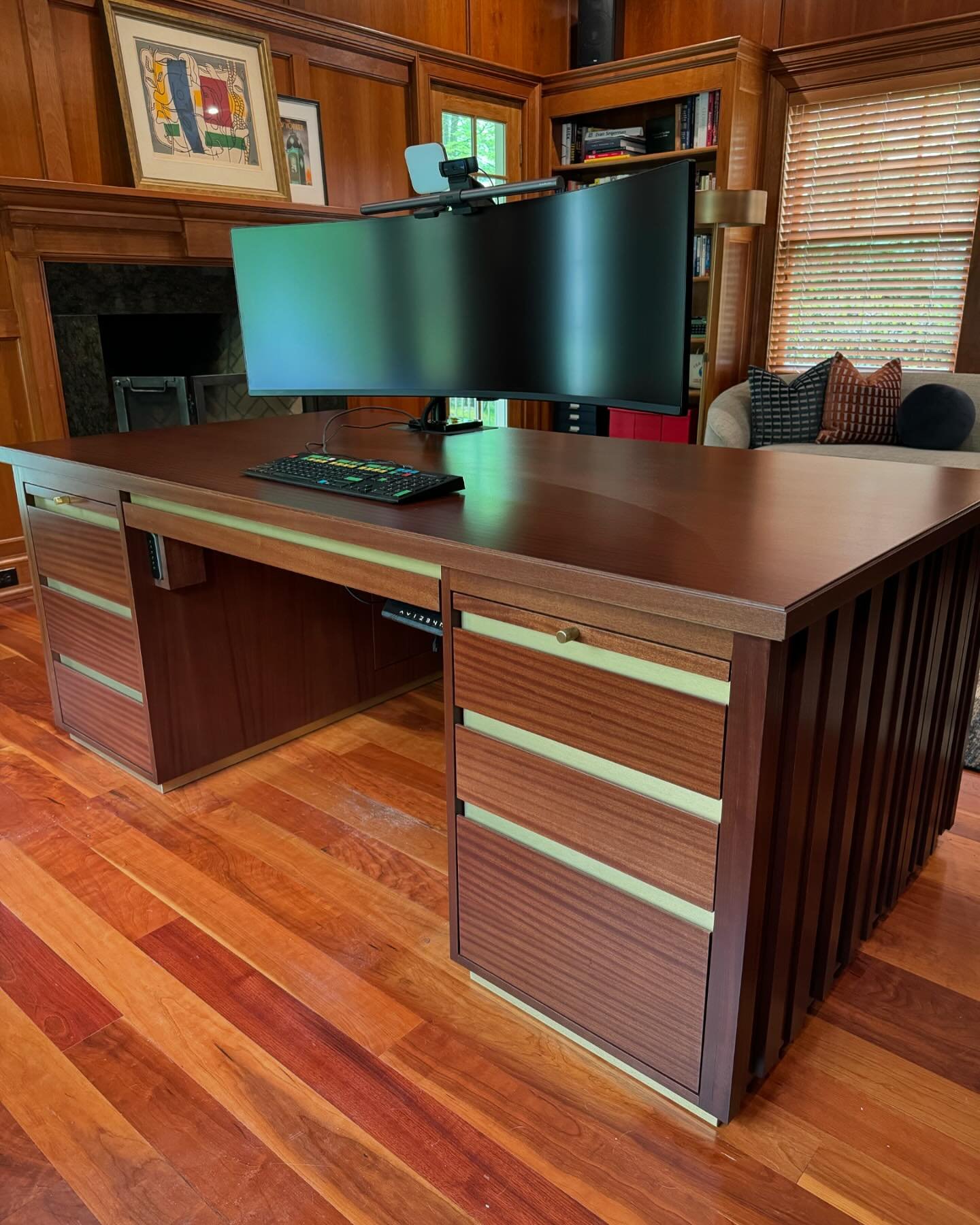 Here is the completed custom sit to stand desk that I designed for a client of mine! We were inspired by the design of a buffet cabinet and decided to apply it to this desk. The wood species is sapele and was stained to match the existing  moldings a
