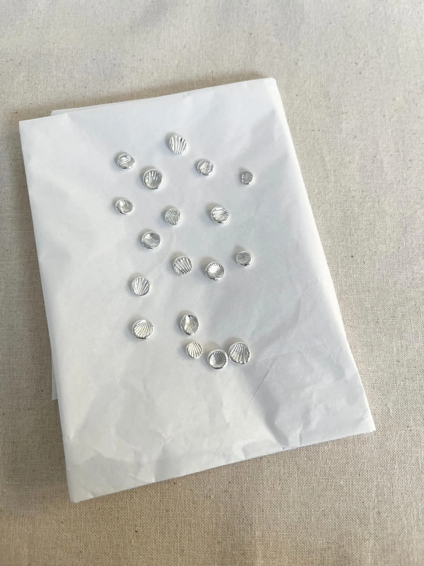 Making little shell charms today from silver clay.