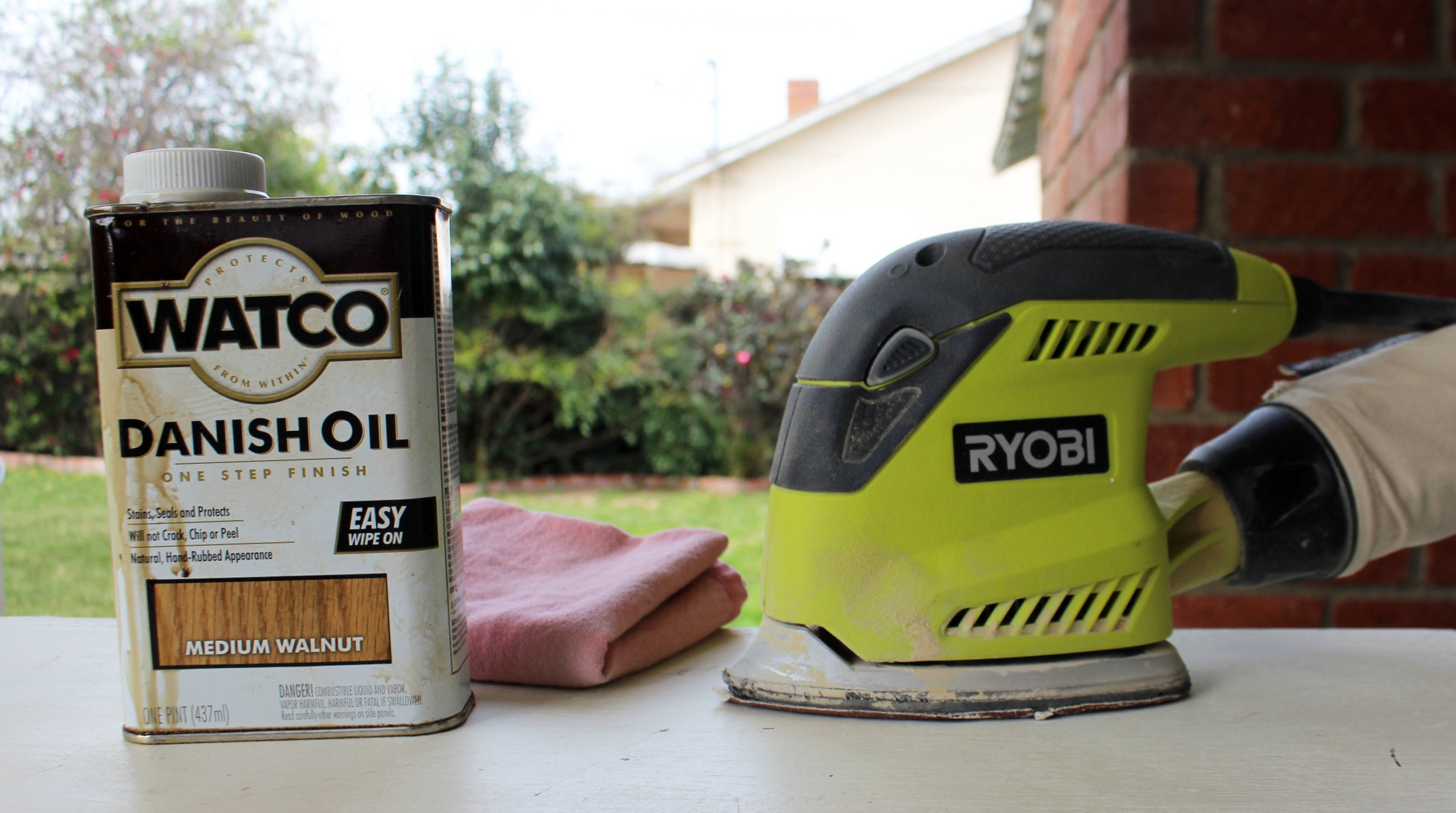 I used Watco Danish Oil in Medium Walnut stain, an old cloth, and an electric sander . The wood oil I chose colors and oils the wood but doesn’t shellac like other stains. If you’d like a glossier finish, you might want to consider this type of wood stain.