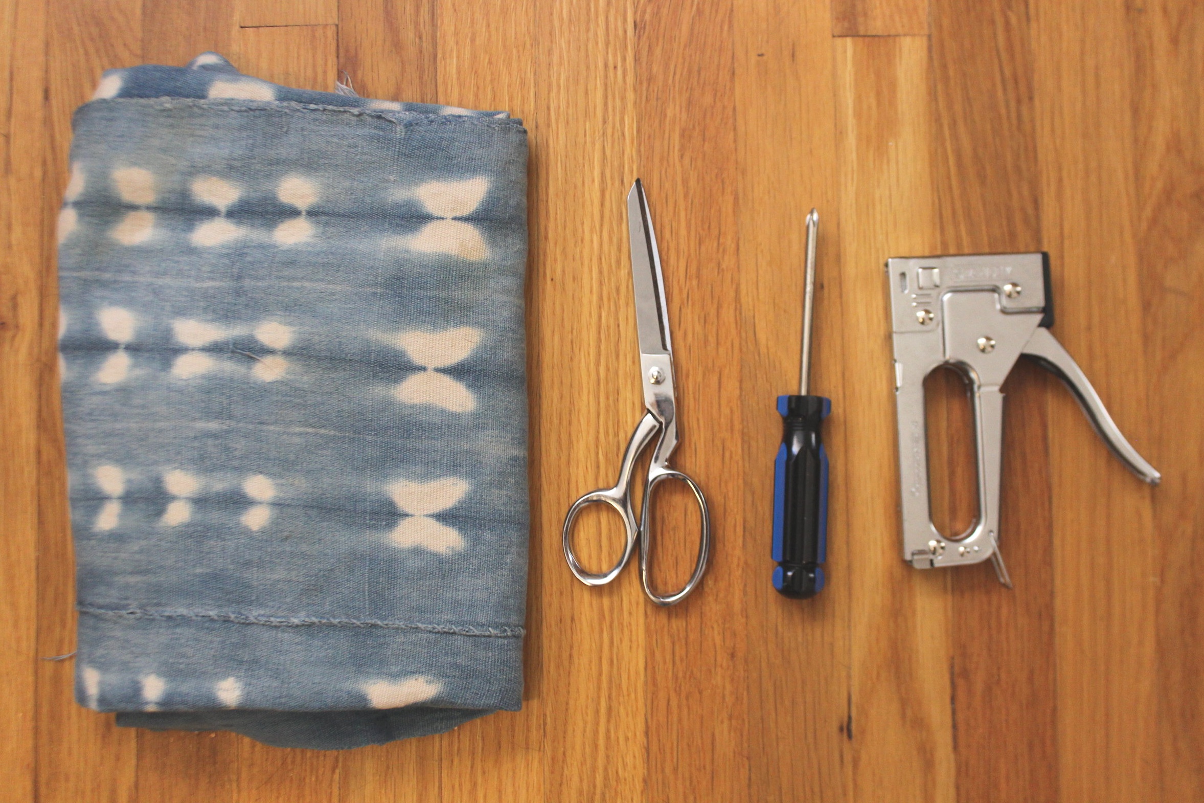 Fabric, fabric scissors, screwdriver, staple gun. Not pictured: staple gun remover.