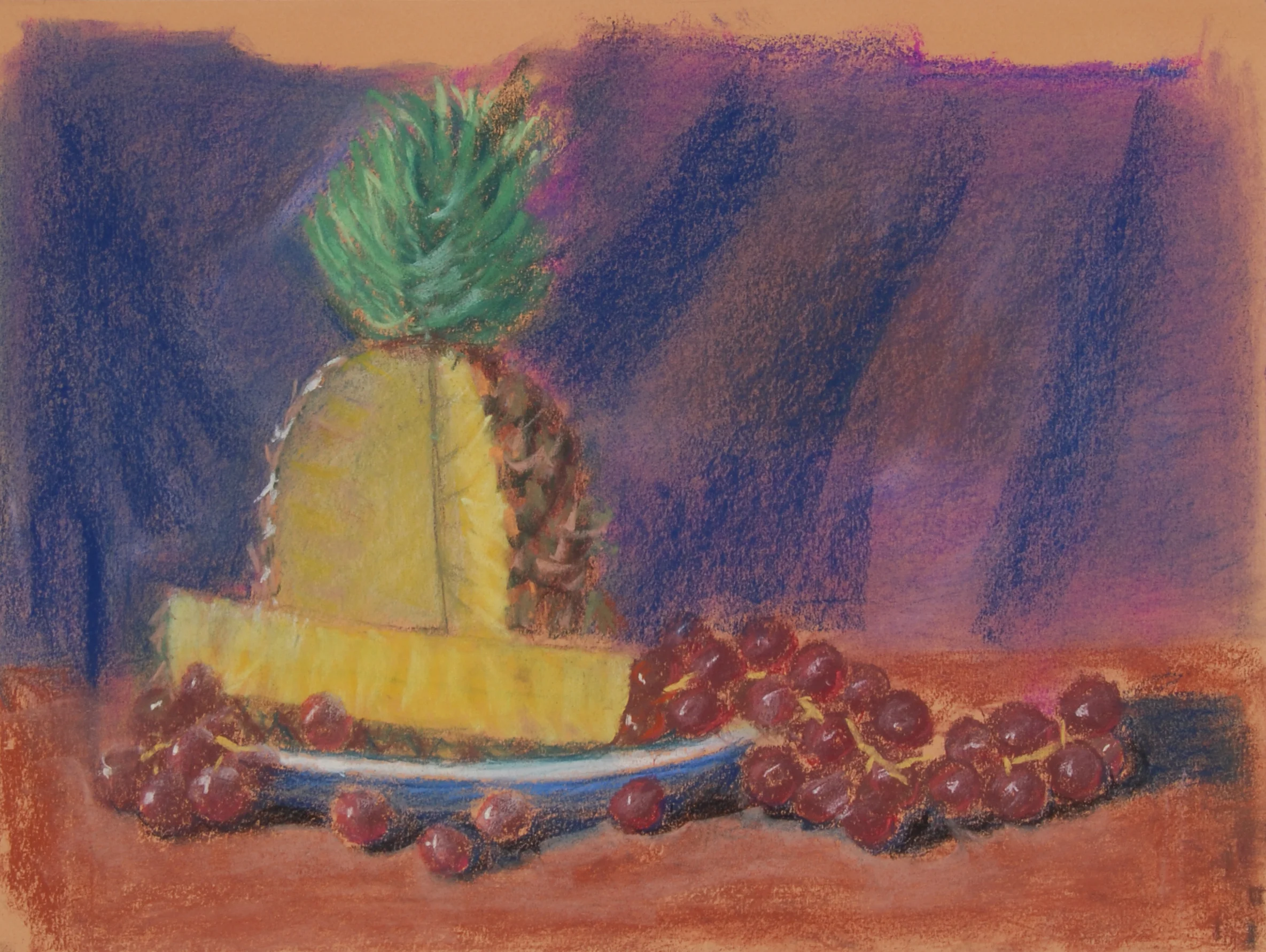 Image #0049: Pineapple on blue plate with red grapes on sides
