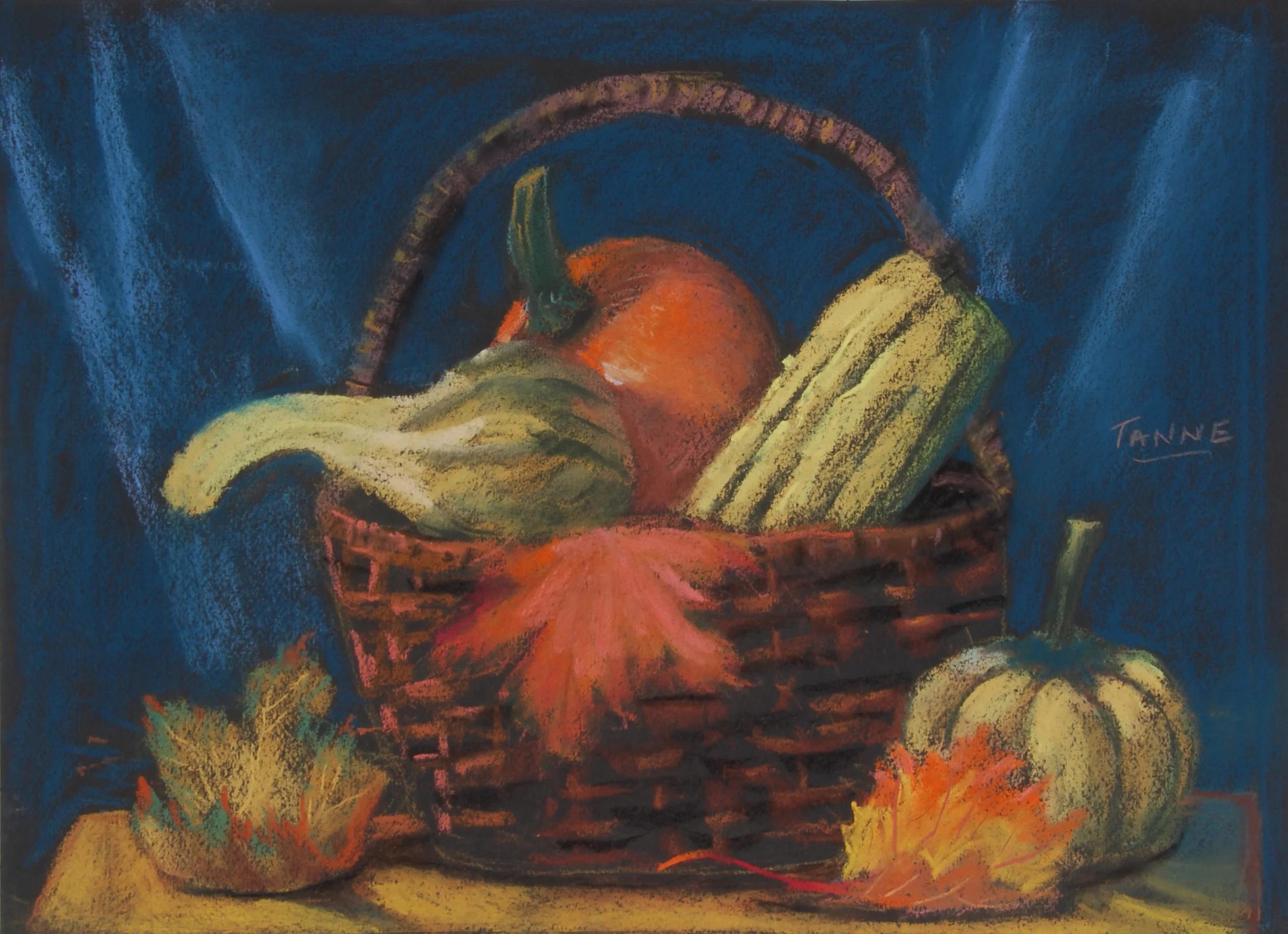 Image #0067: Squash inside a brown basket, one pumpkin in the middle, autumn leaves in basket and on sides