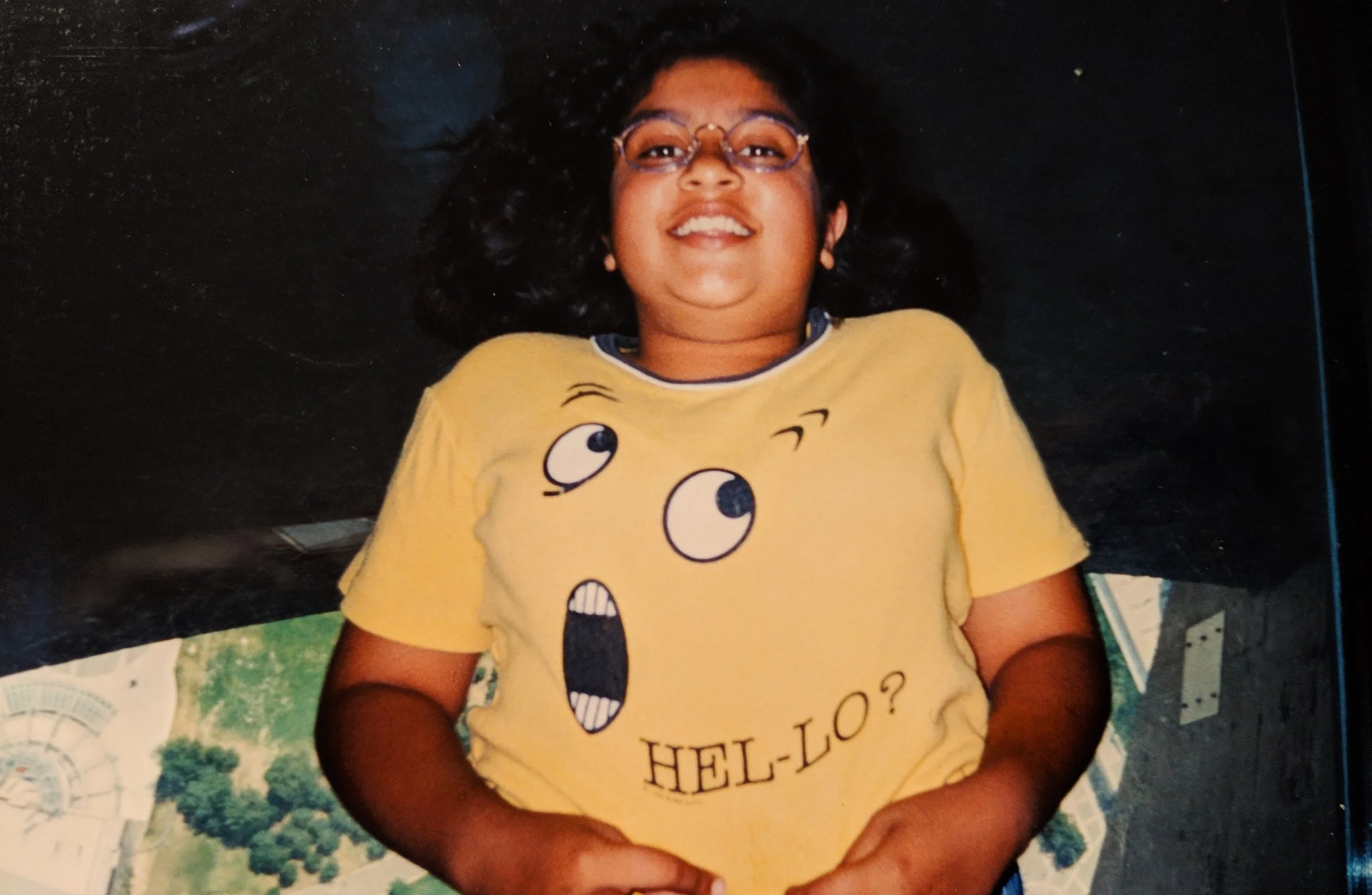 Me at 11 or 12 years old while lying on the glass floor at the CN Tower, wearing my favourite t-shirt at the time.