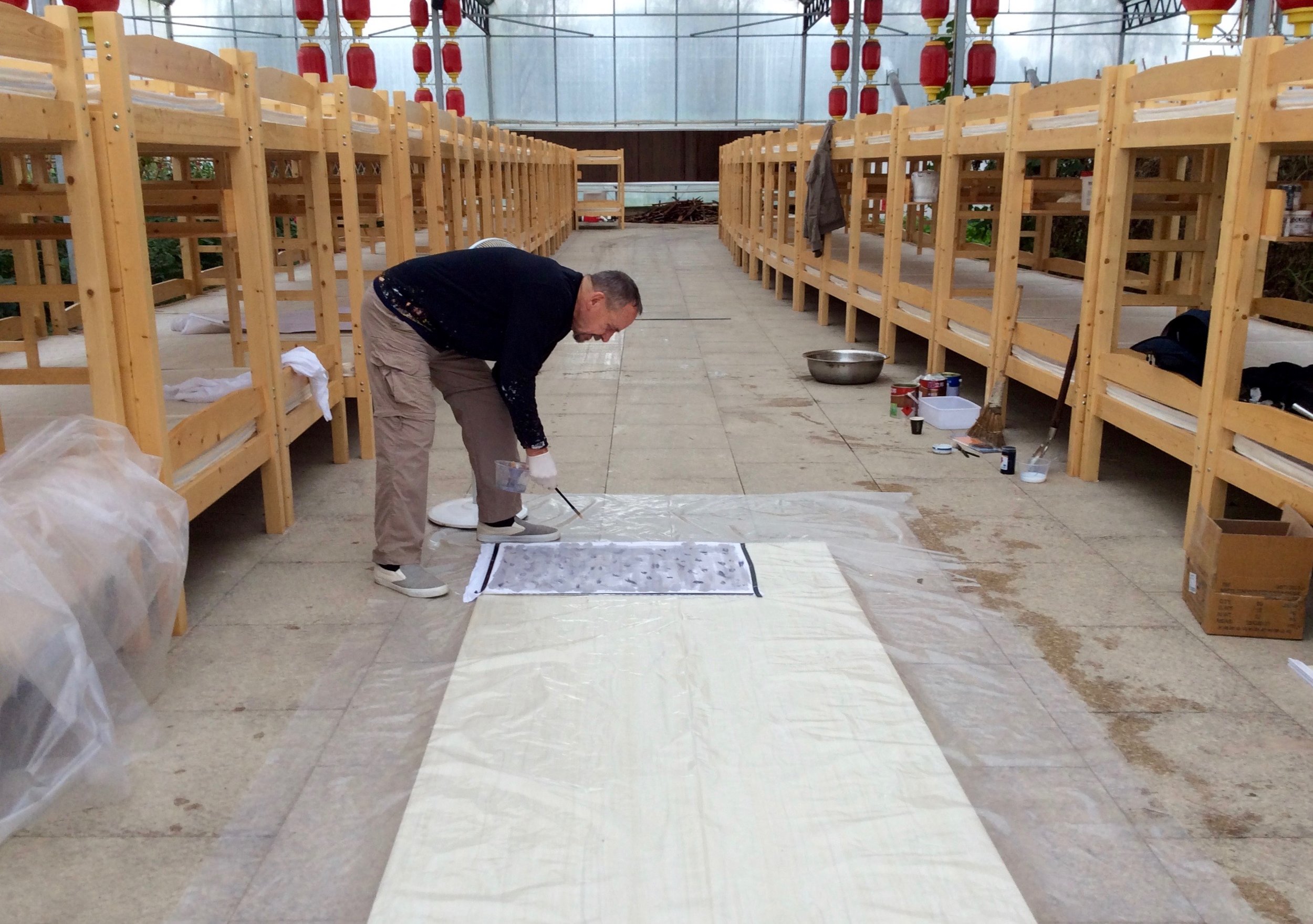 Robert Scott working in The Peach Blossom Hotel's greenhouse. 