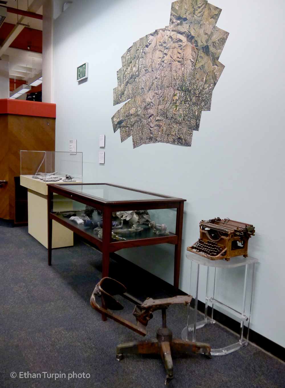 Burnt objects found on the ground after a fire, are seen here under a map of its territory. 