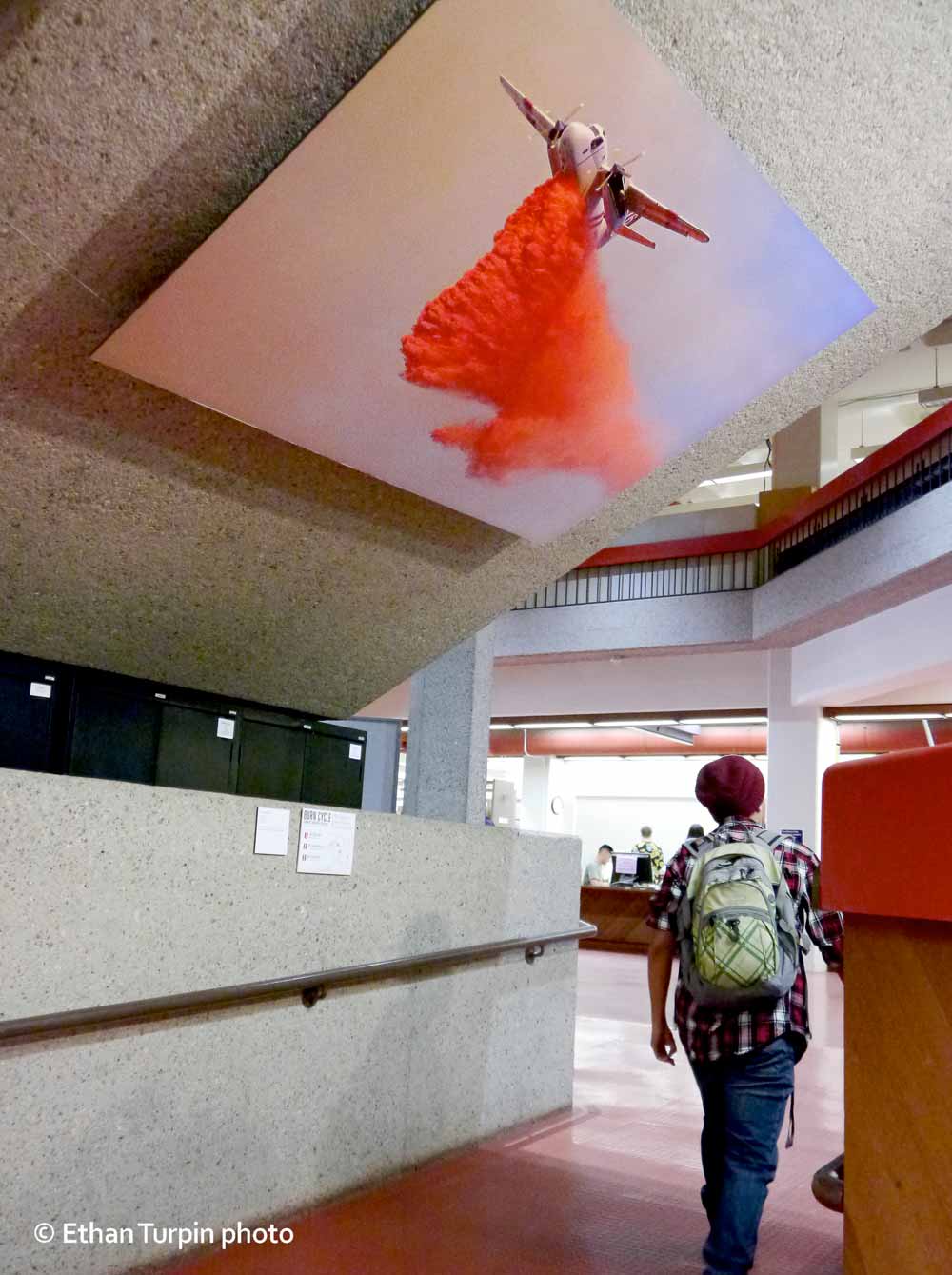 A staircase helped create a photographic experience of aerial firefighting and helped to personalize conversations about fire management. Air tanker image by Eric Isaacs