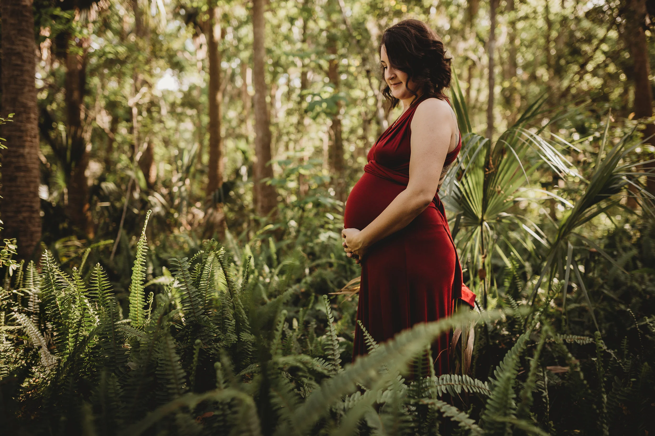 Daytona Beach Maternity photographer capturing emotive images at Sugar Mill Gardens in Port Orange