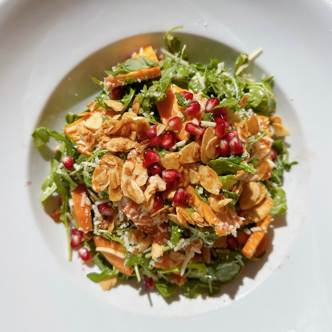 Our Market Salad is quickly becoming a staff and guest favorite! Enjoy its harvest flavors of arugula, roasted sweet potatoes, shaved parmesan, pomegranate seeds, roasted almonds and honey-pomegranate vinaigrette.