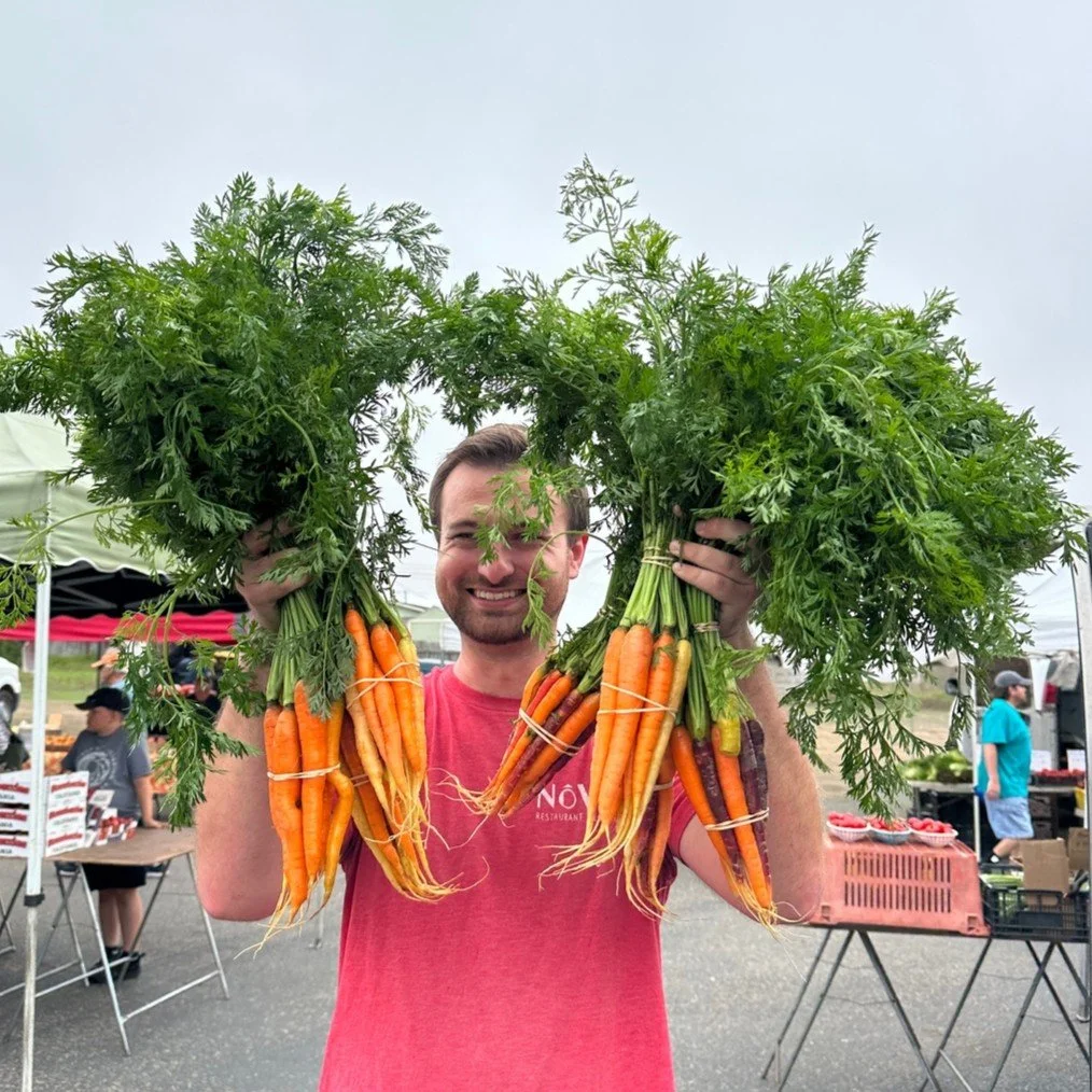 Fall harvest is here! Our produce purveyor, James, is clearly excited about these colorful carrots from the Morro Bay Farmer's Market. 🍂